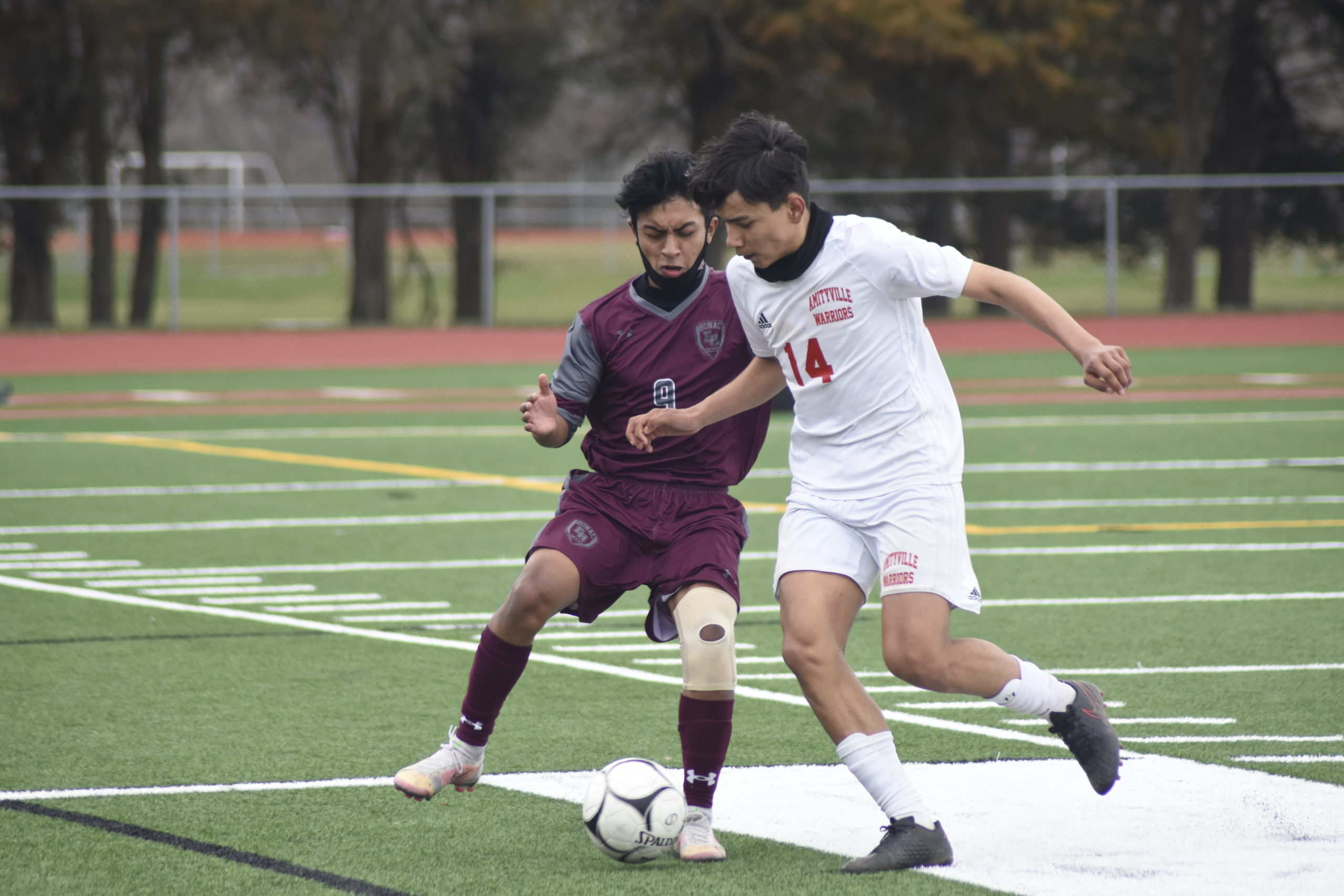 East Hampton sophomore Eric Armijos braces for impact from an Amityville player.