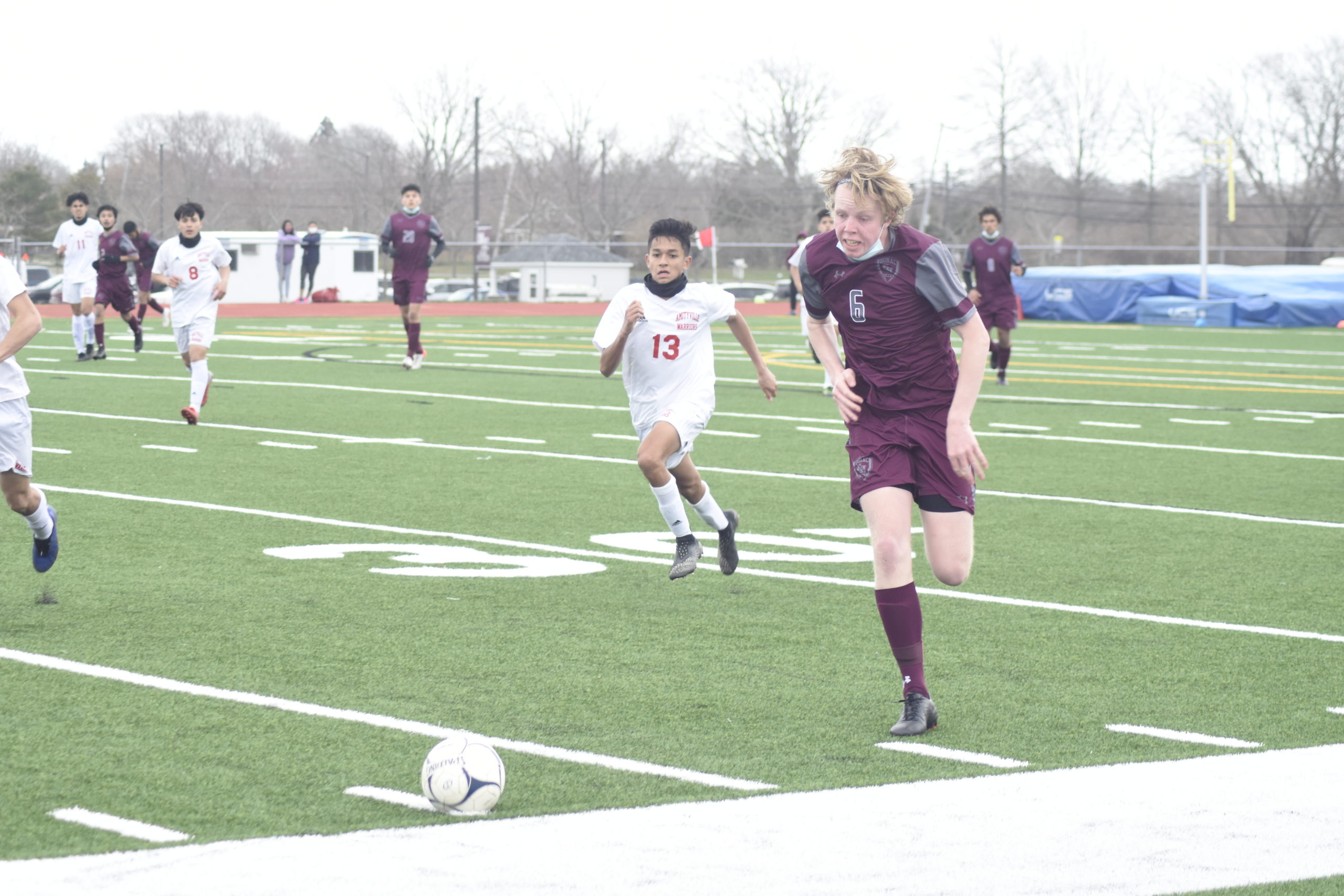 East Hampton senior Matthew McGovern races after a bouncing ball.