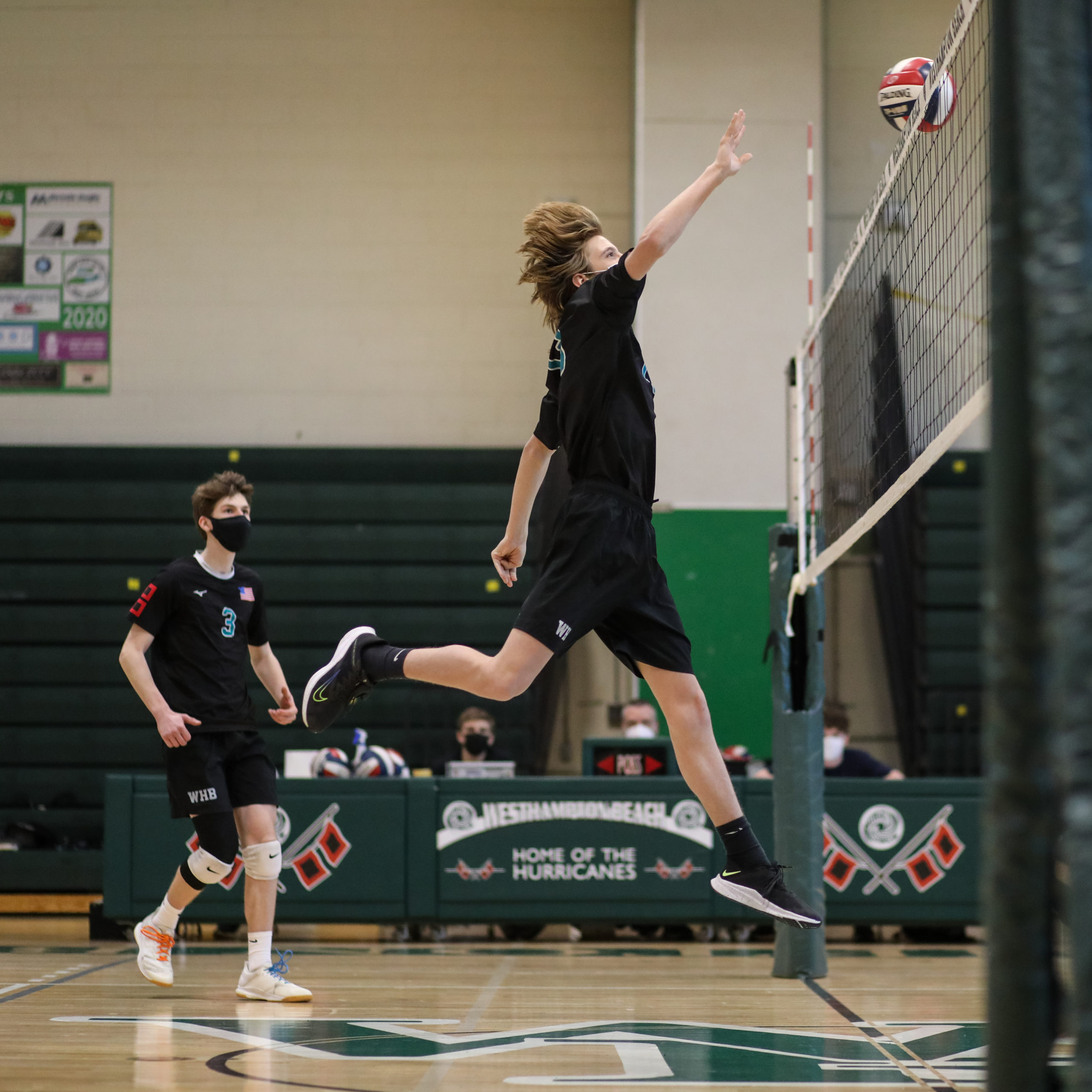 Westhampton Beach middle hitter Connor Gromely sends the ball over the net.