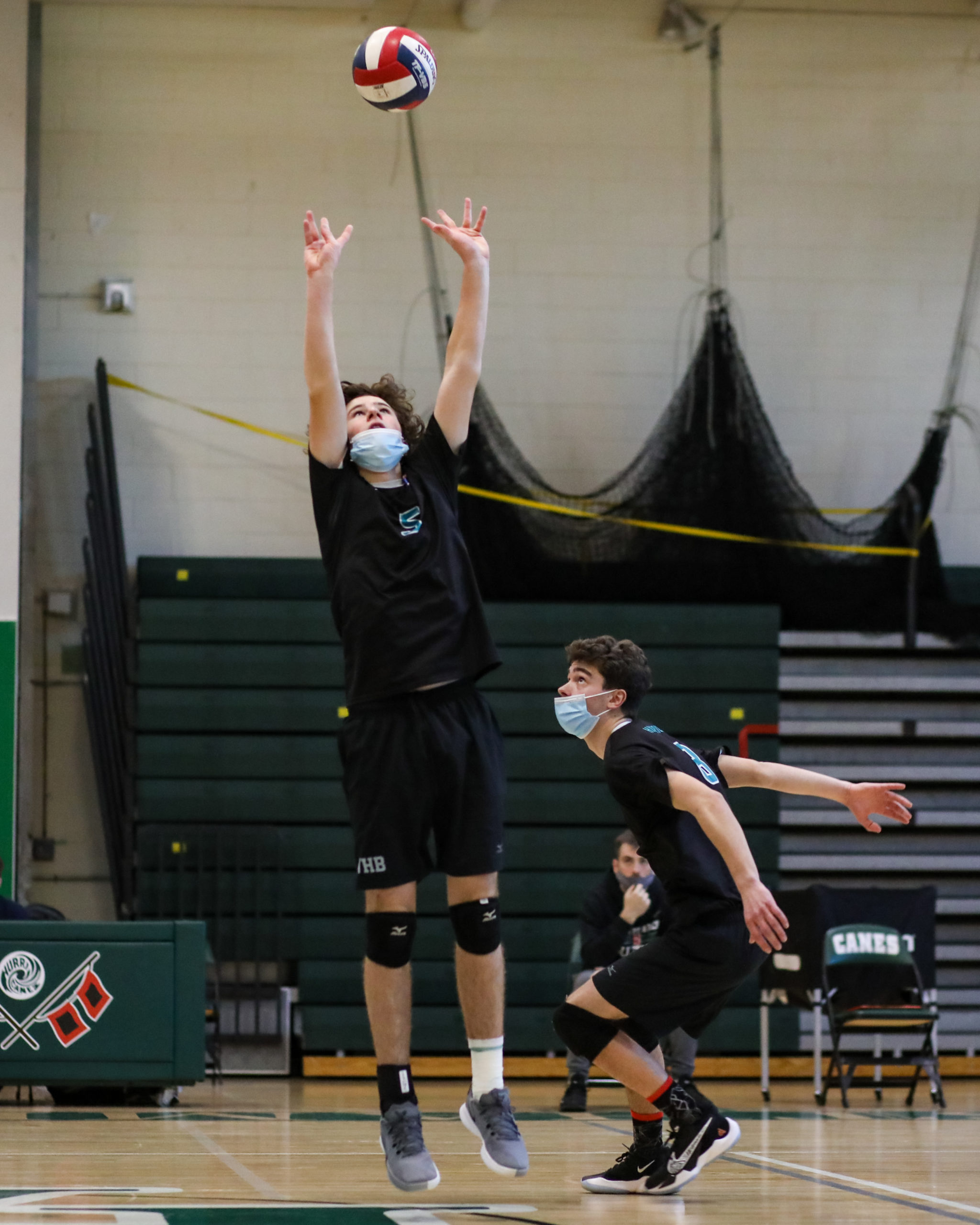 Westhampton Beach setter Conor Farnan sets up the ball for middle hitter Colbie Mason.