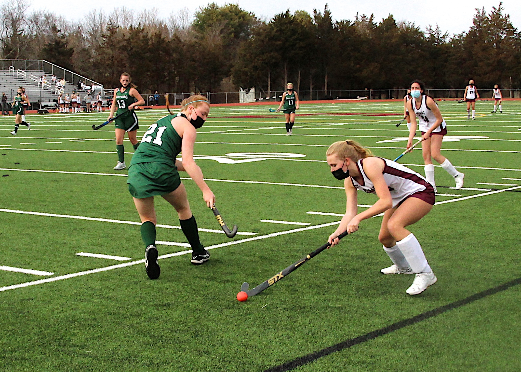 East Hampton junior Hanna Medler keeps the ball away from a Harborfields player.