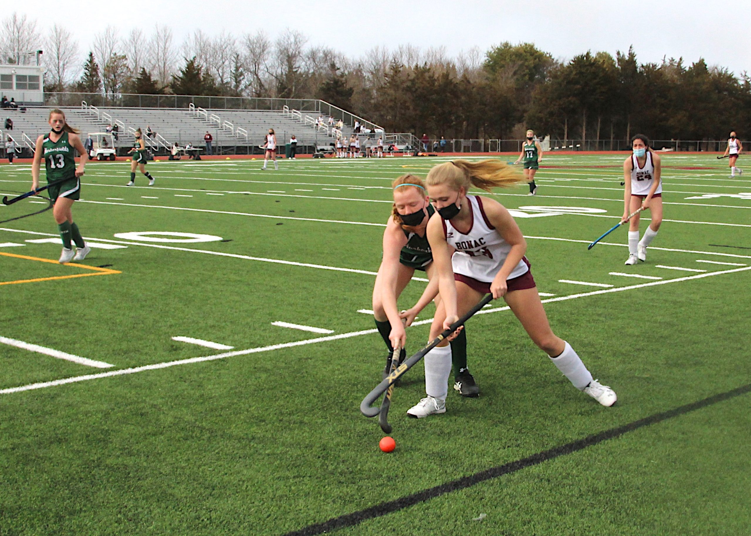 East Hampton junior Hanna Medler keeps the ball away from a Harborfields player.