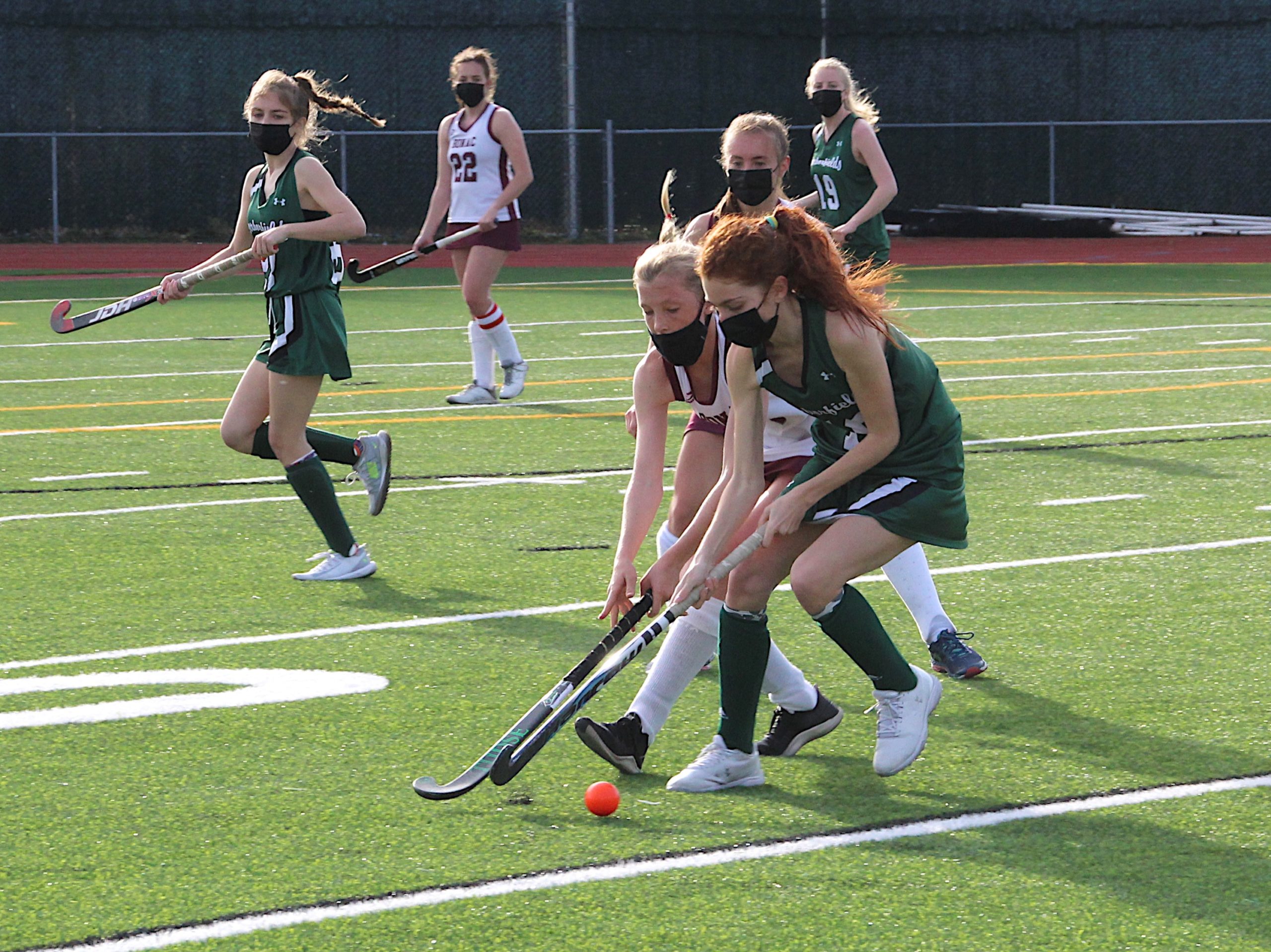 East Hampton sophomore Chloe Coleman battles for ball control with a Harborfields player.