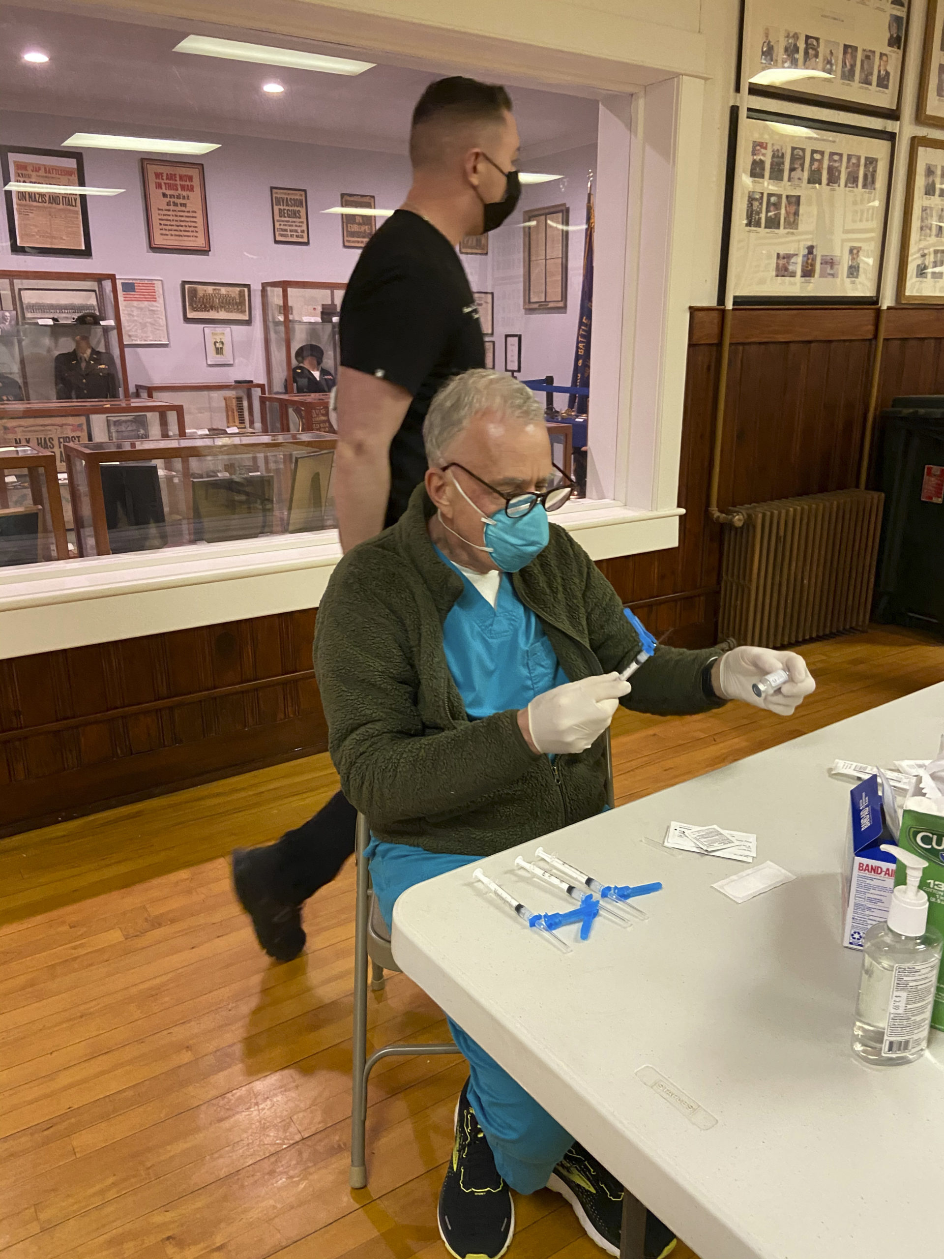 Dr. John Oppenheimer prepares vaccines at the popup vaccination center at the American Legion in Sag Harbor.