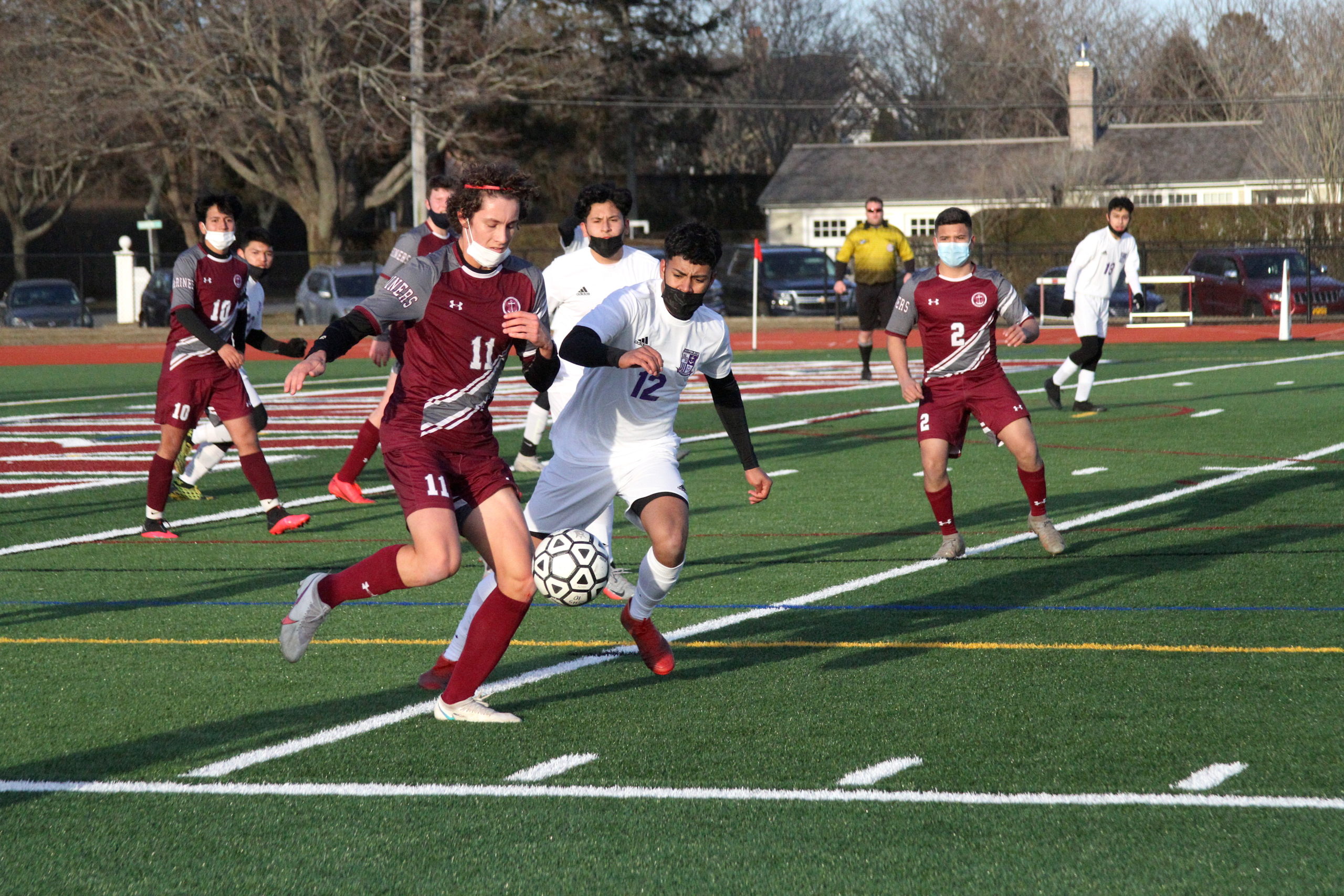 Southampton junior forward Patrick Matthews dribbles while Hampton Bays junior midfielder Nico Carmona stays on his hip.