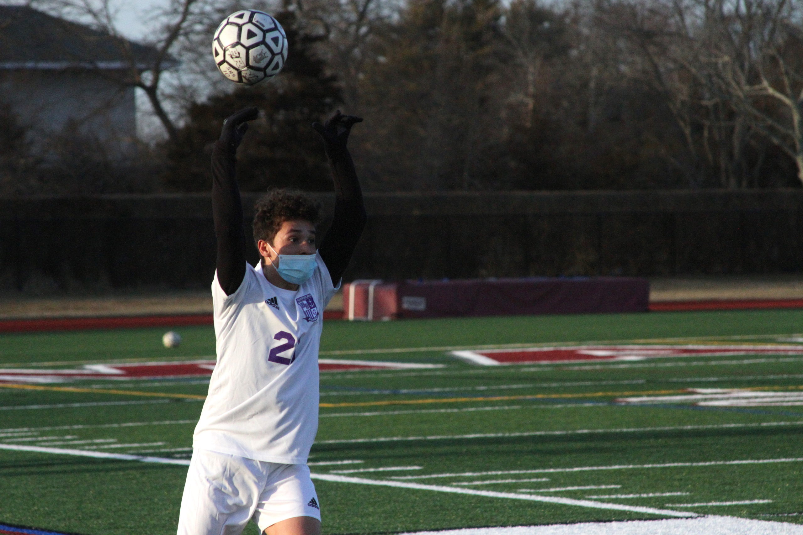 Hampton Bays senior defender Esteban Vasquez tosses the ball into play.