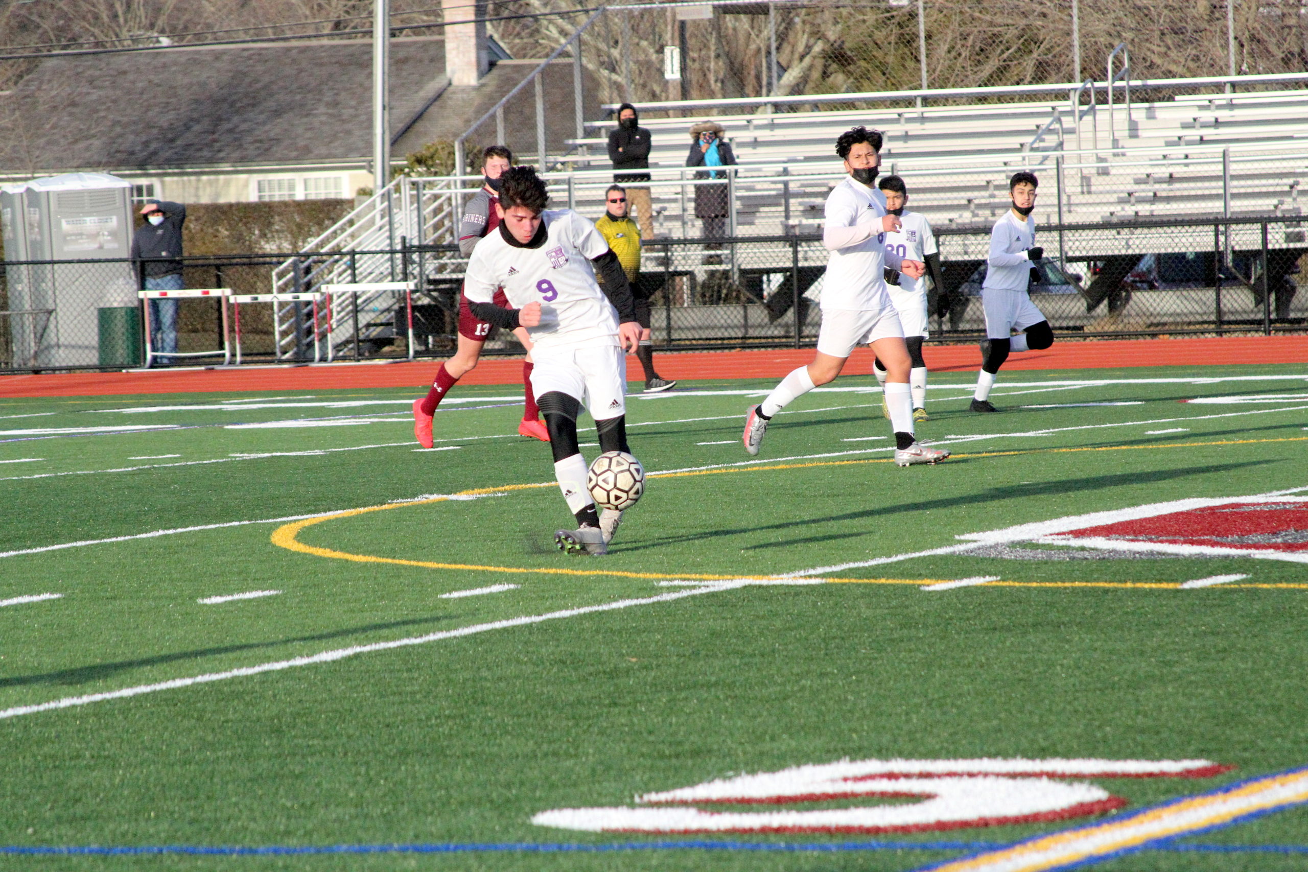 Hampton Bays senior center midfielder Cris Vasquez passes the ball.