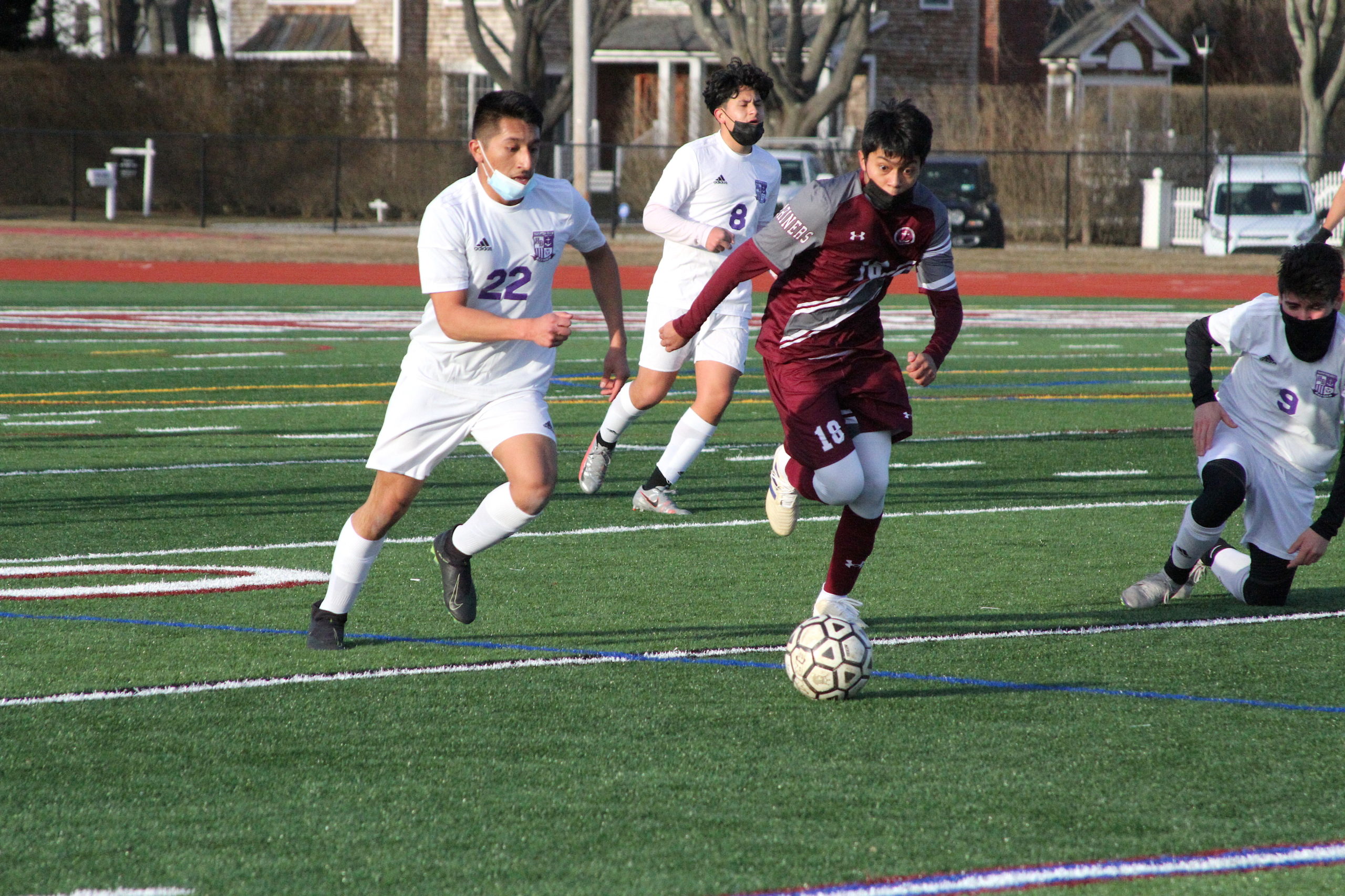 Hampton Bays senior midfielder and forward Danny Alvarracin and Southampton senior midfielder Huriel Reyes race toward the loose ball.