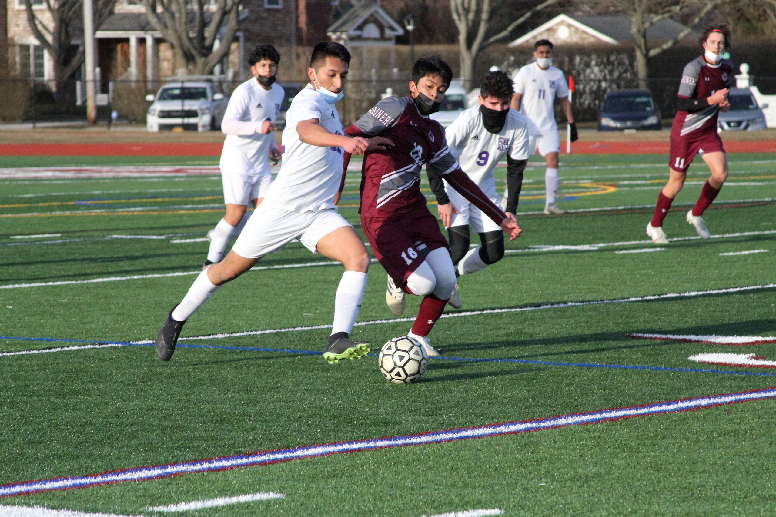 Hampton Bays senior midfielder and forward Danny Alvarracin and Southampton senior midfielder Huriel Reyes fight for possession.