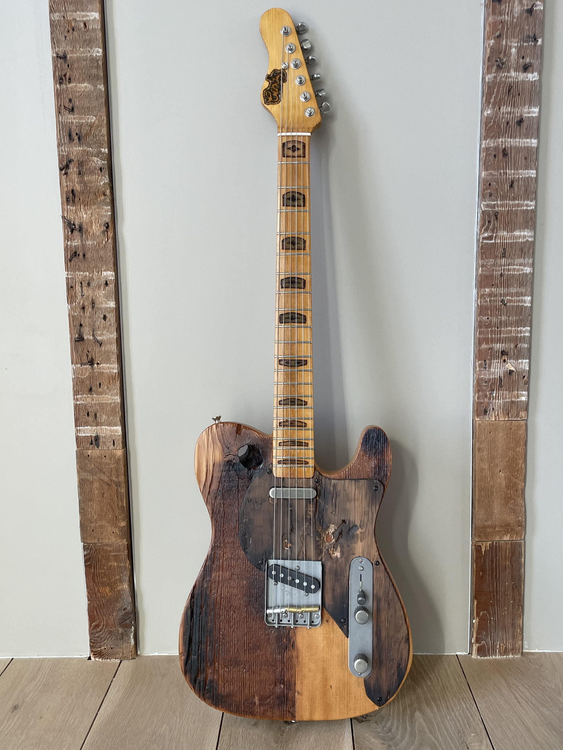 A guitar made from wood from The Church by Carmine Street Guitars. Notice the knot hole on the upper left of the instrument.