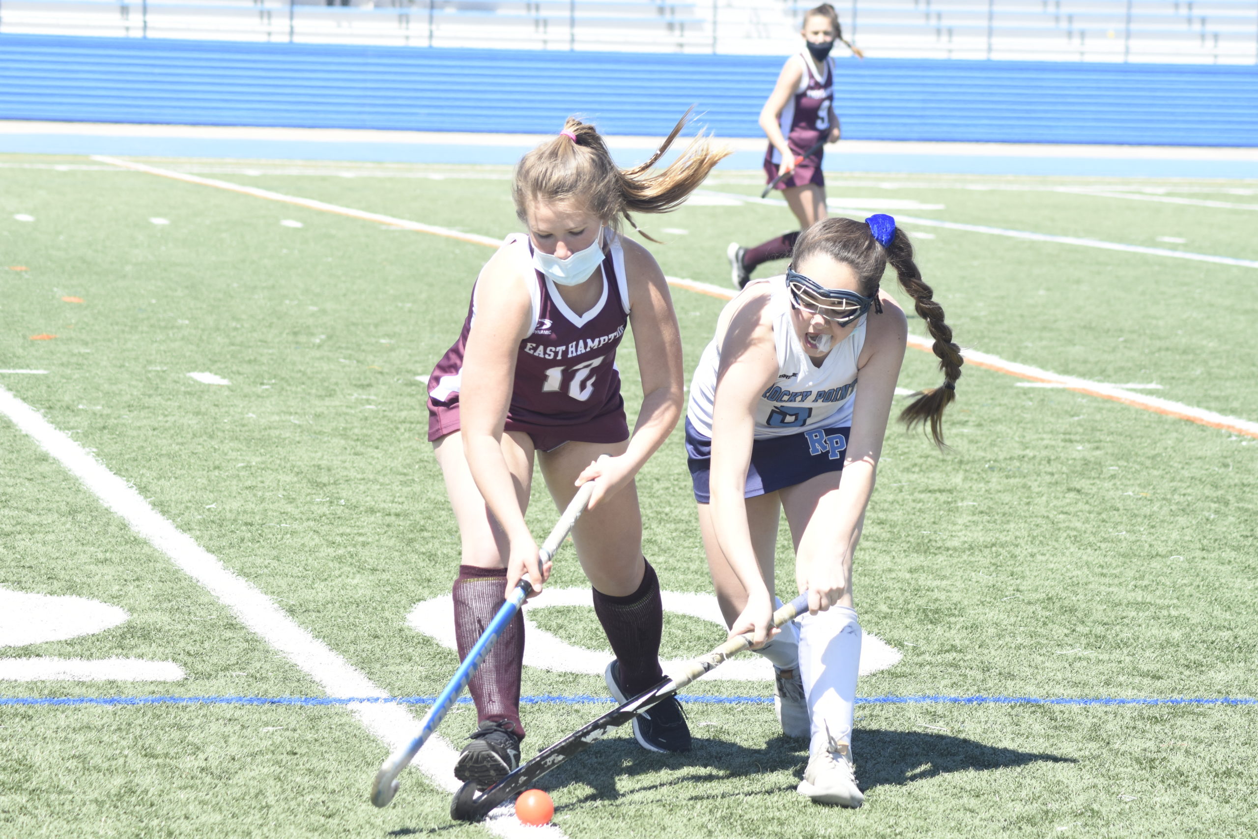 East Hampton junior Arabella Kuplins and a Rocky Point player go for the ball.