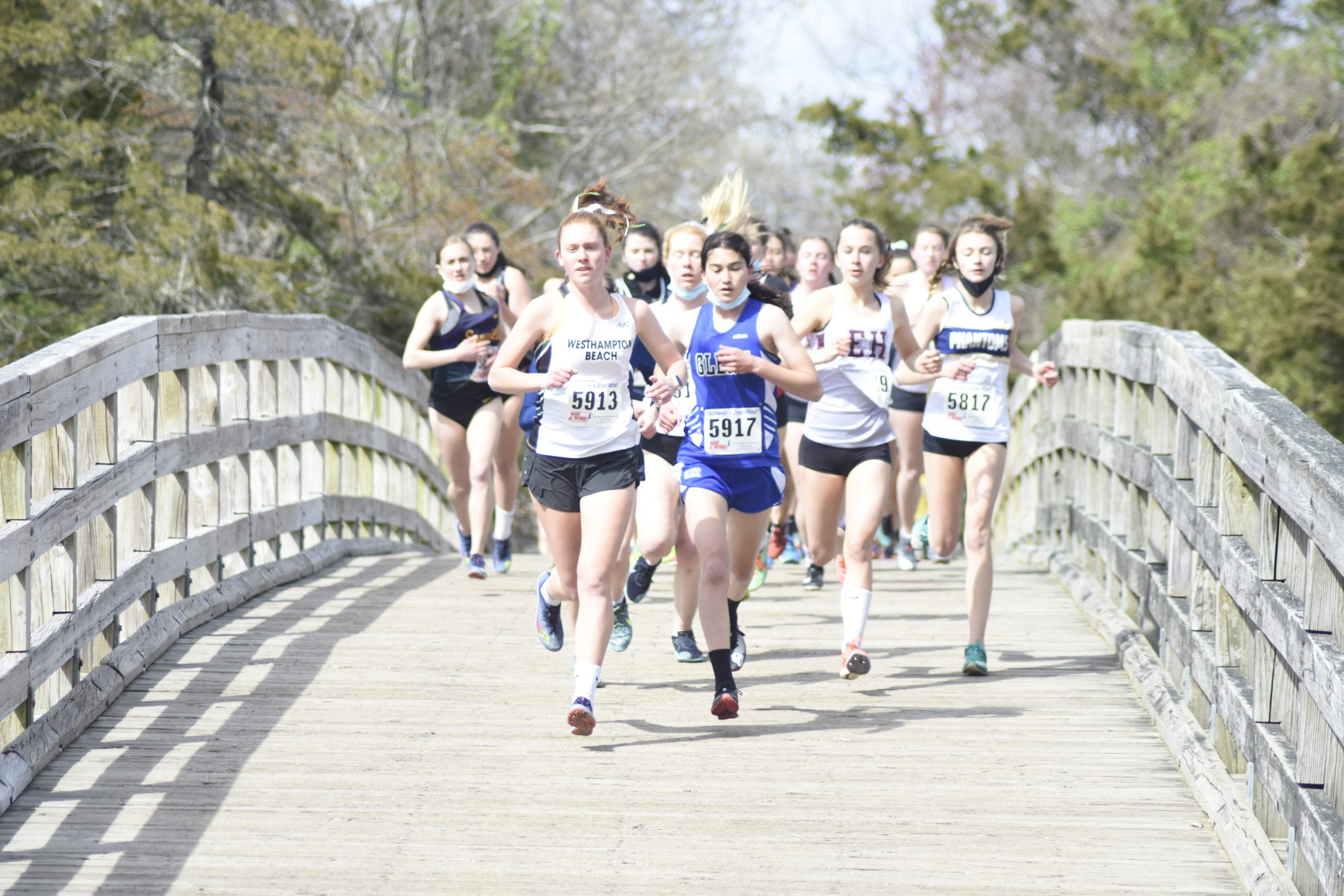 Westhampton Beach senior Jackie Amato leads the 'B' race over the bridge at the beginning of the course at Sunken Meadow.