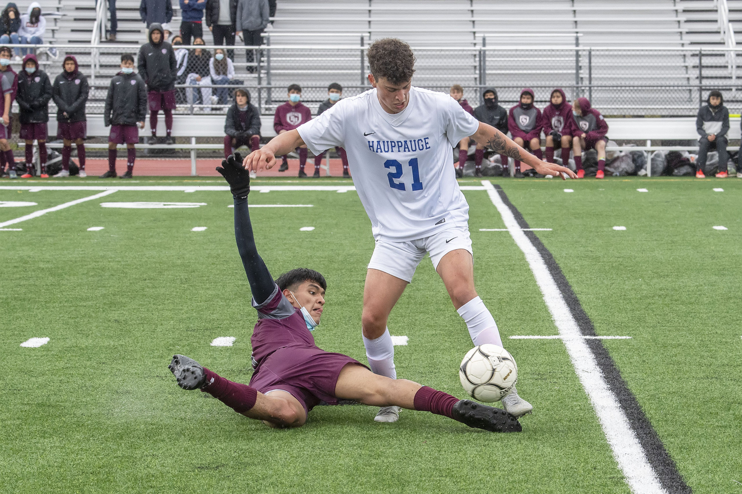 An East Hampton player tries to play the ball while falling down.