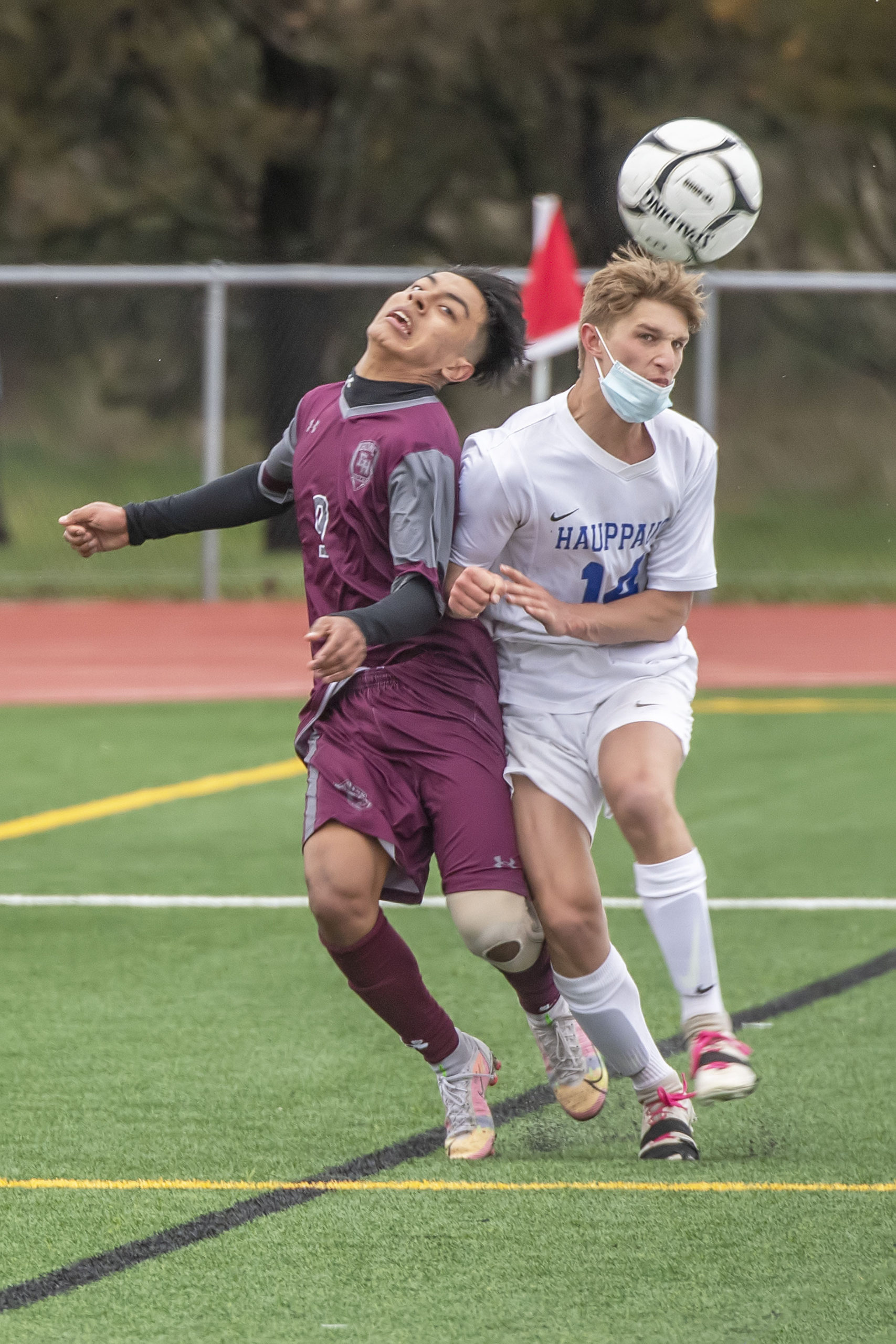 East Hampton sophomore Eric Armijos gets pushed from behind by a Hauppauge player.