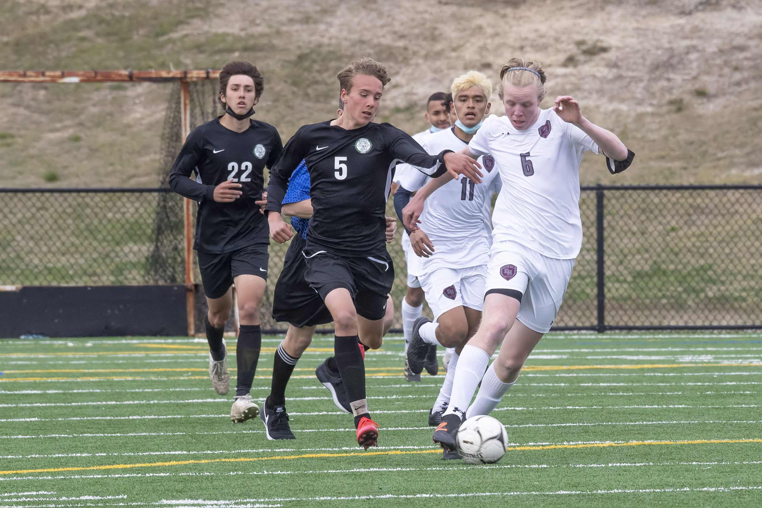 East Hampton's Matt McGovern leads a fast break, leaving behind Liam Harrington of Harborfields.