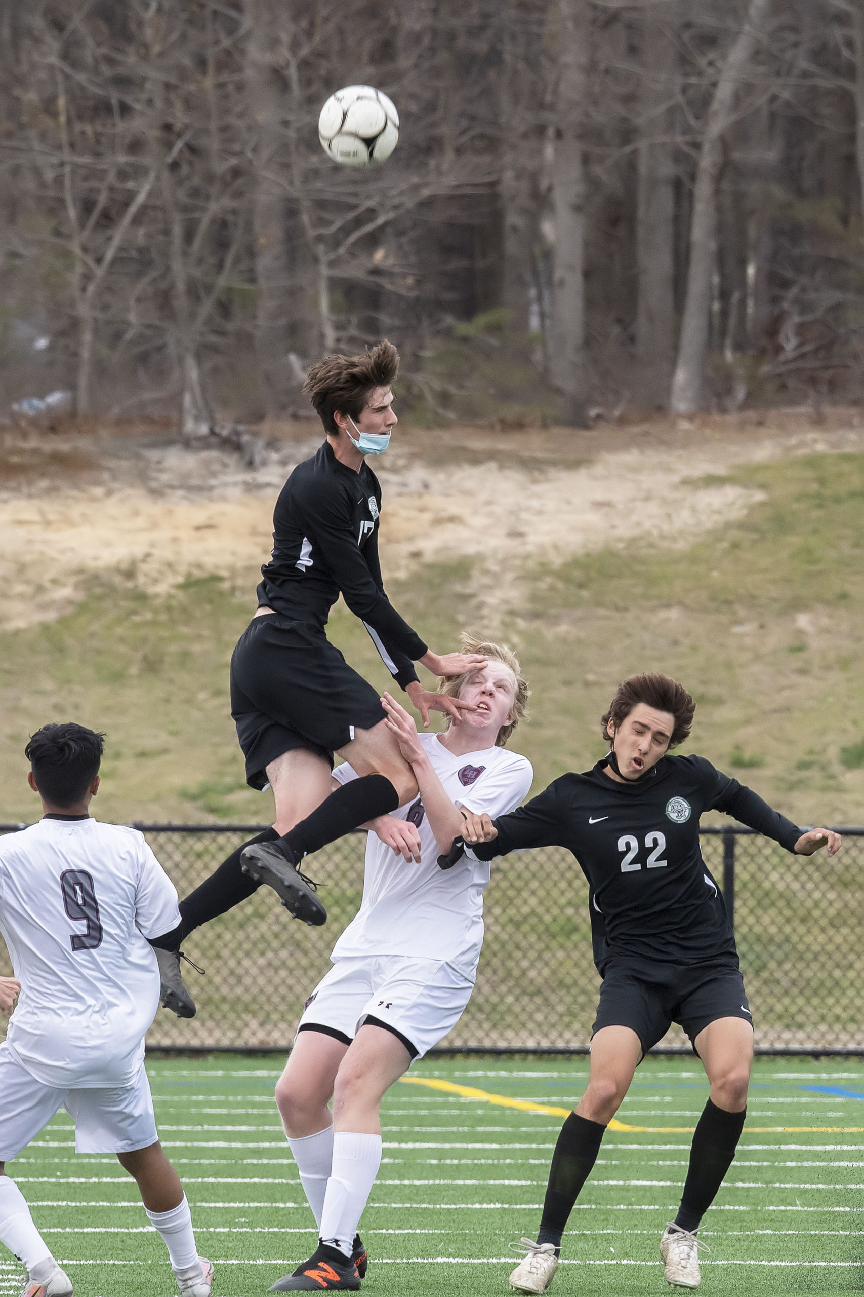 East Hampton's Matt McGovern takes a hit from Nicholas Ruisi of Harborfields.