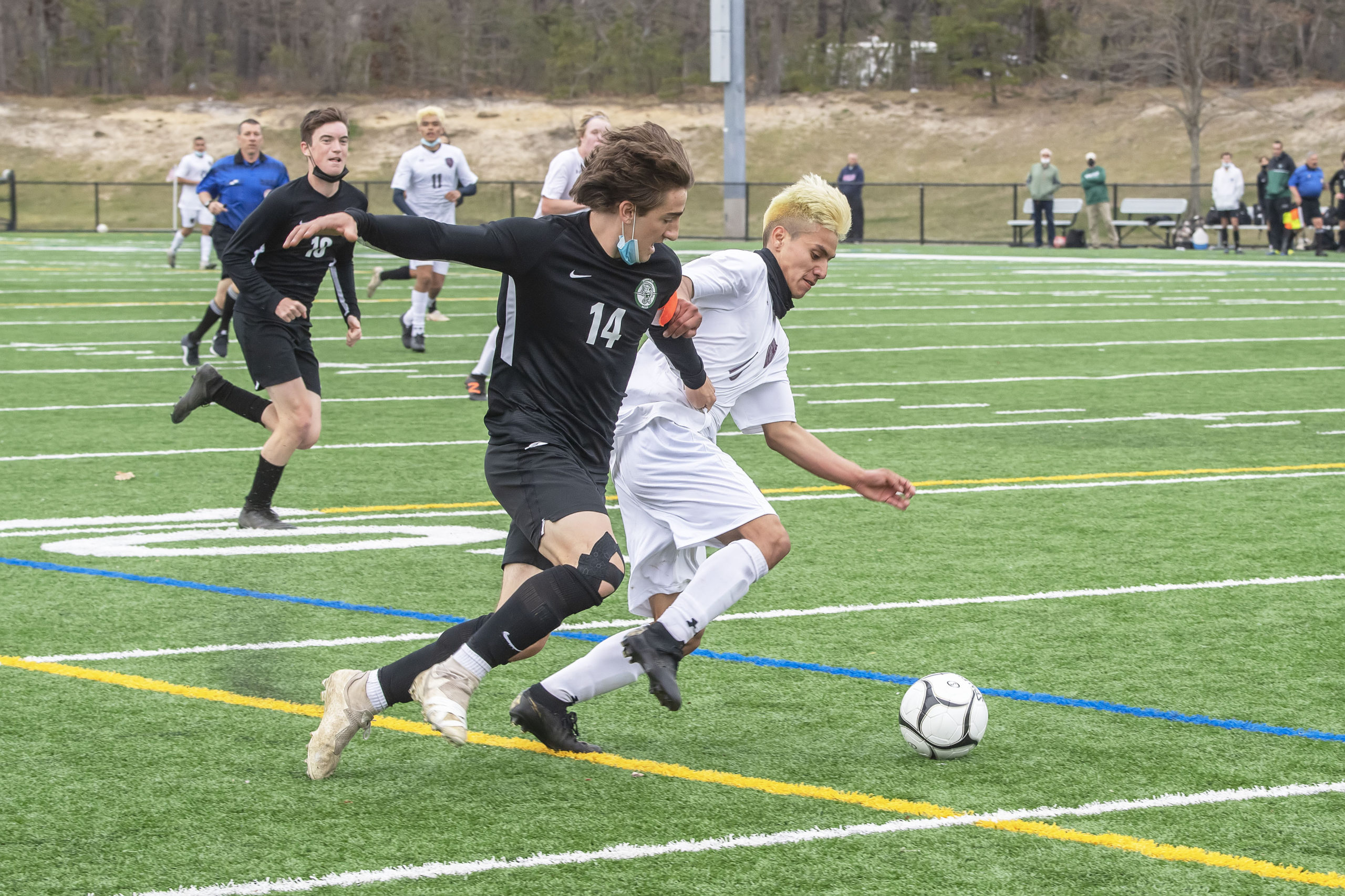 East Hampton's Christopher Pintado fights to keep control of the ball with Aidan Cuthbertson of Harborfields.