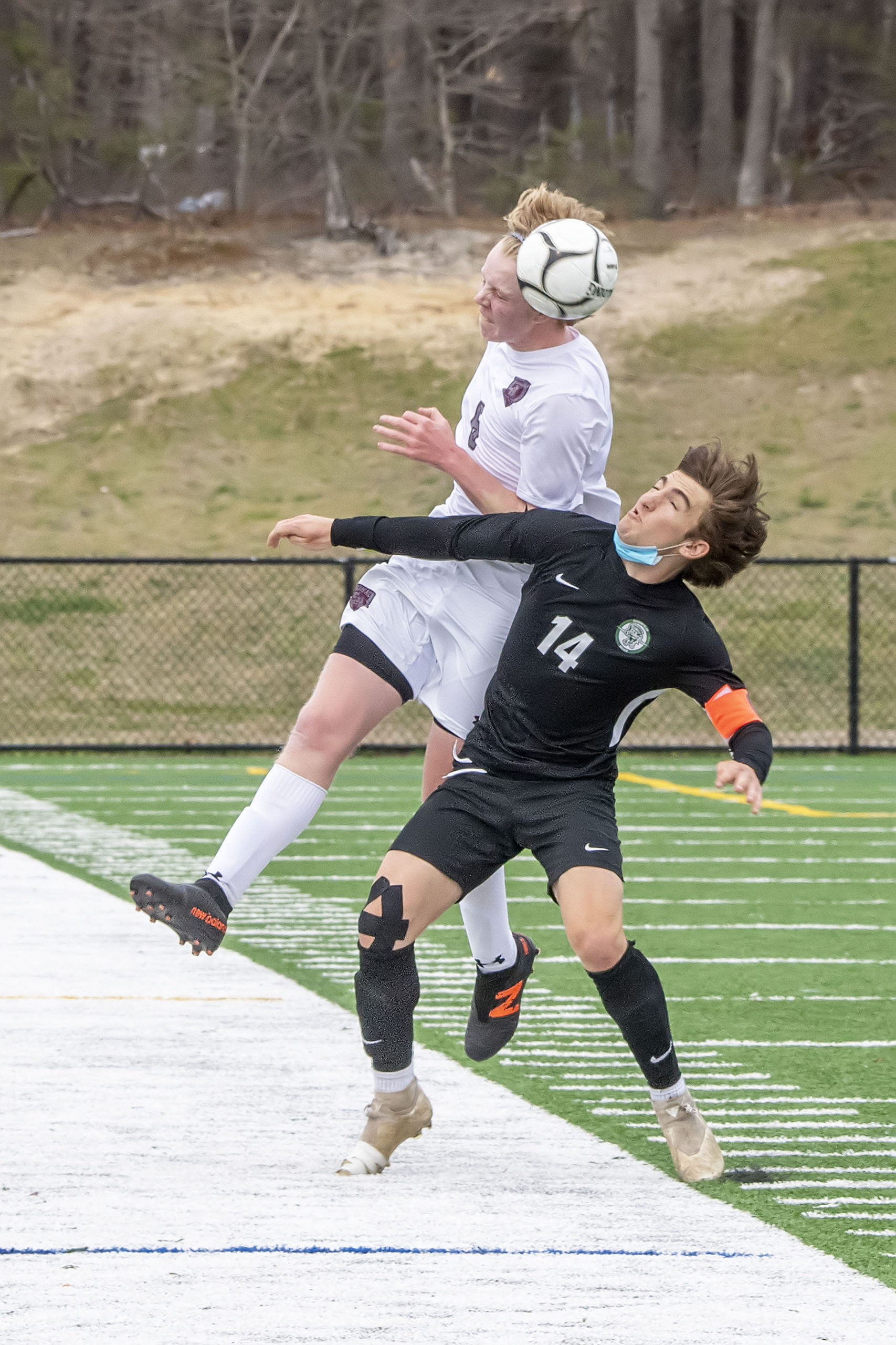 East Hampton's Matt McGovern wins the fight for a header over Aidan Cuthbertson of Harborfields.