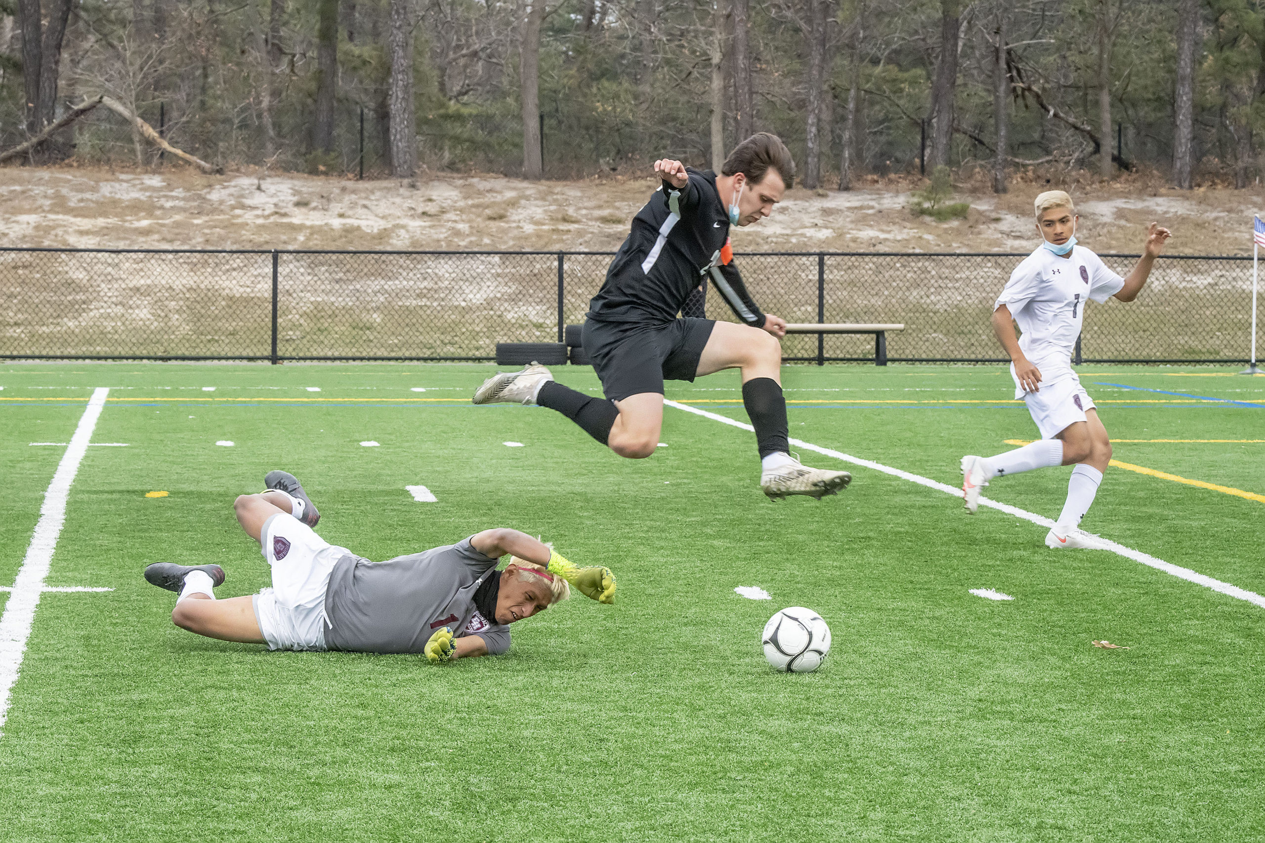 Tyler Axelsen of Harborfields gets by East Hampton goalie Christopher Barahona.