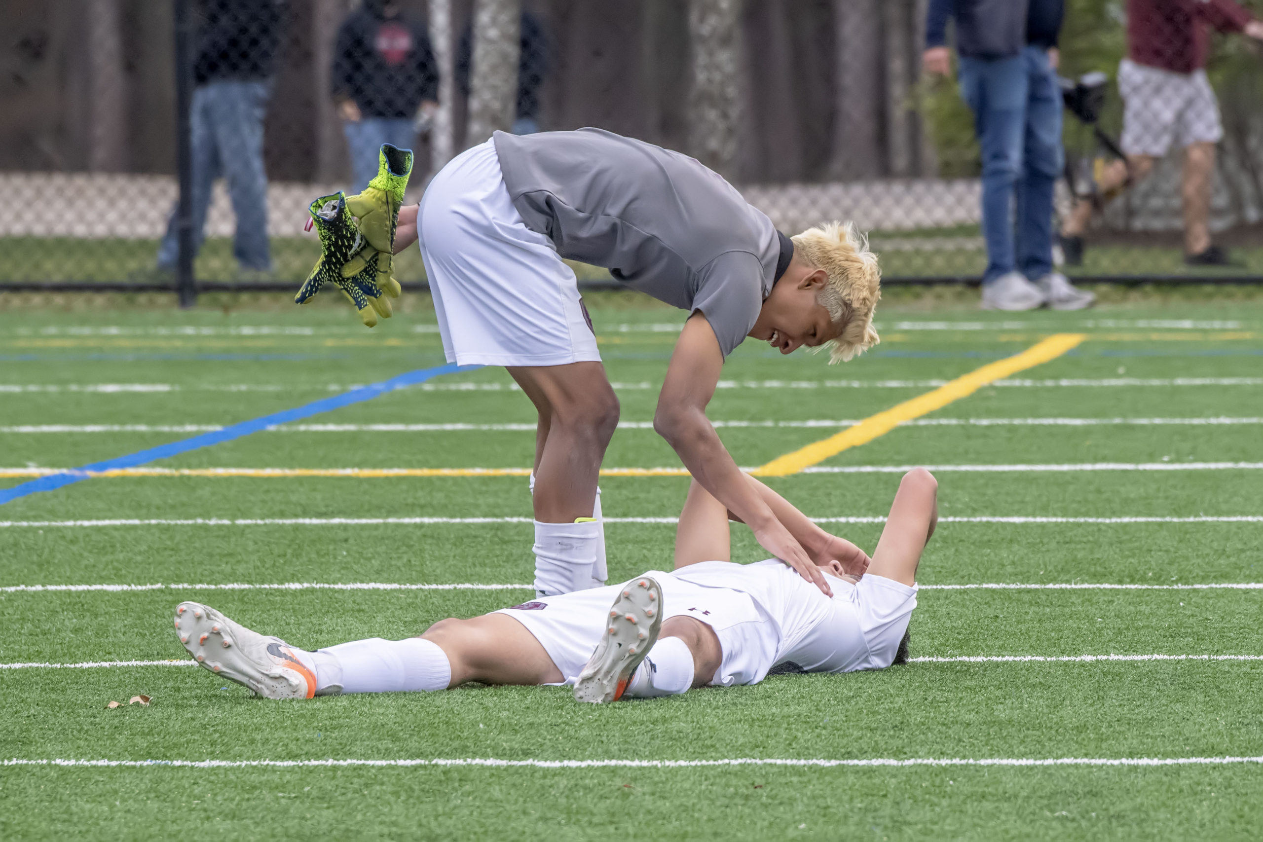 East Hampton's Christopher Barahona comforts a teammate who had collapsed with grief after losing the Suffolk County Class A Soccer Championship on Saturday.