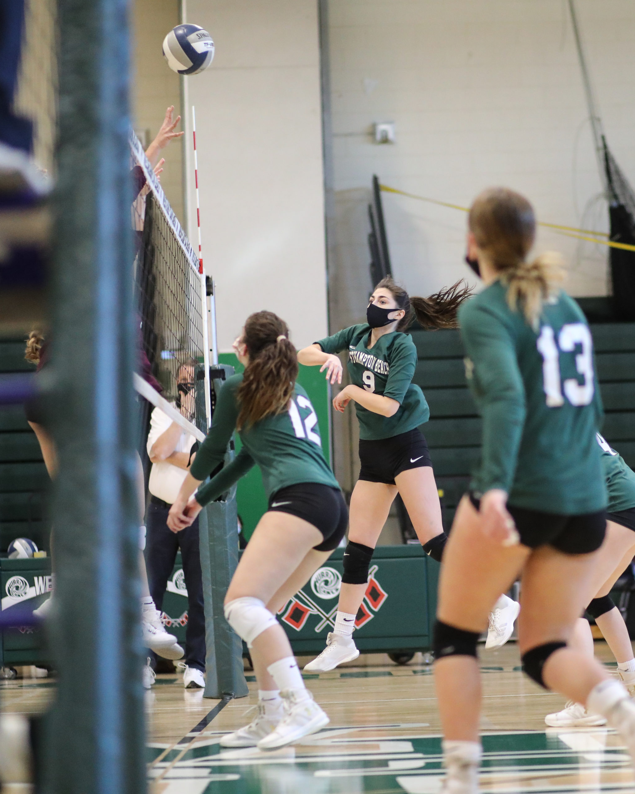 Westhampton Beach senior Jackie Glaser spikes the ball over the net.