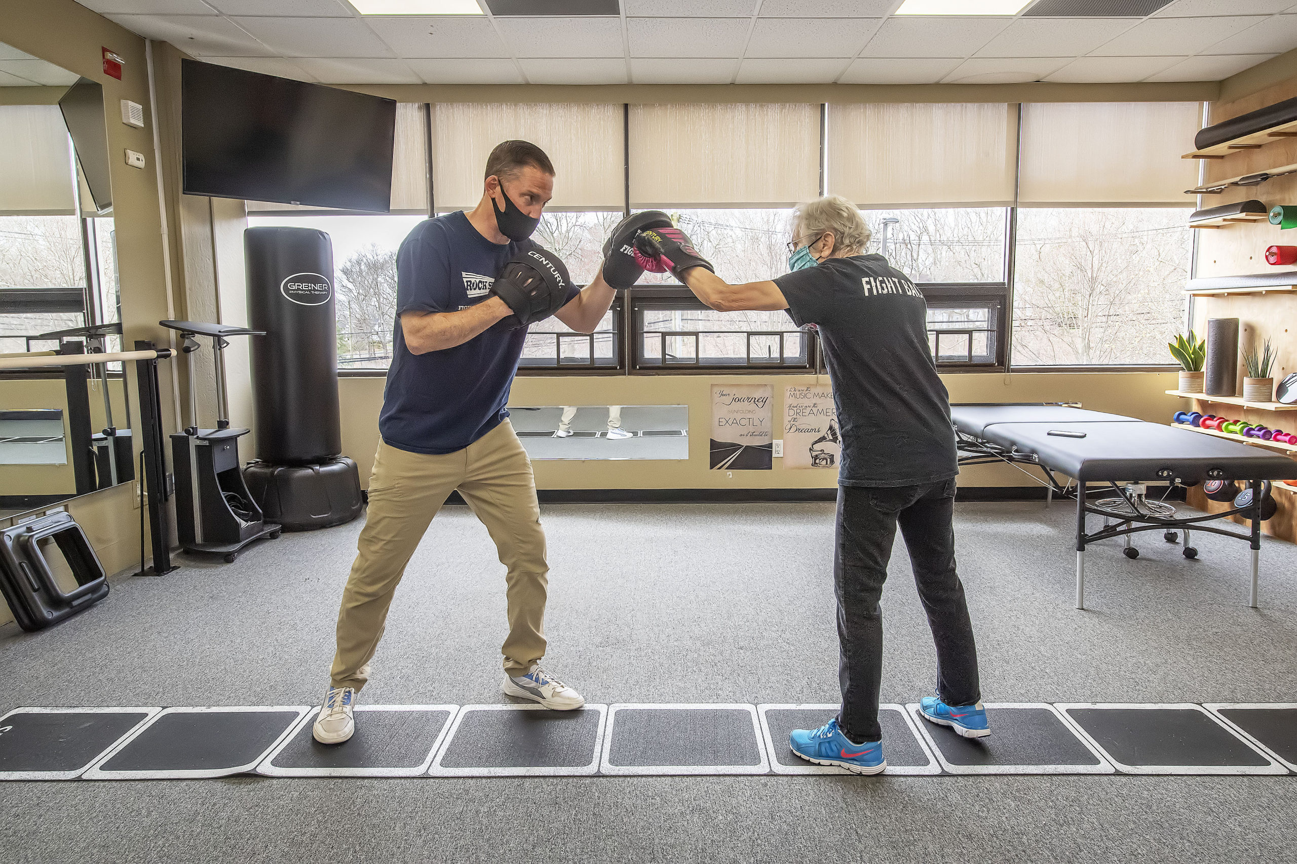 Seth Greiner of Greiner Physical Therapy does a Rock Steady Boxing workout with Parkinson's patient Janet Barr at the Greiner Physical Therapy studio in Speonk.