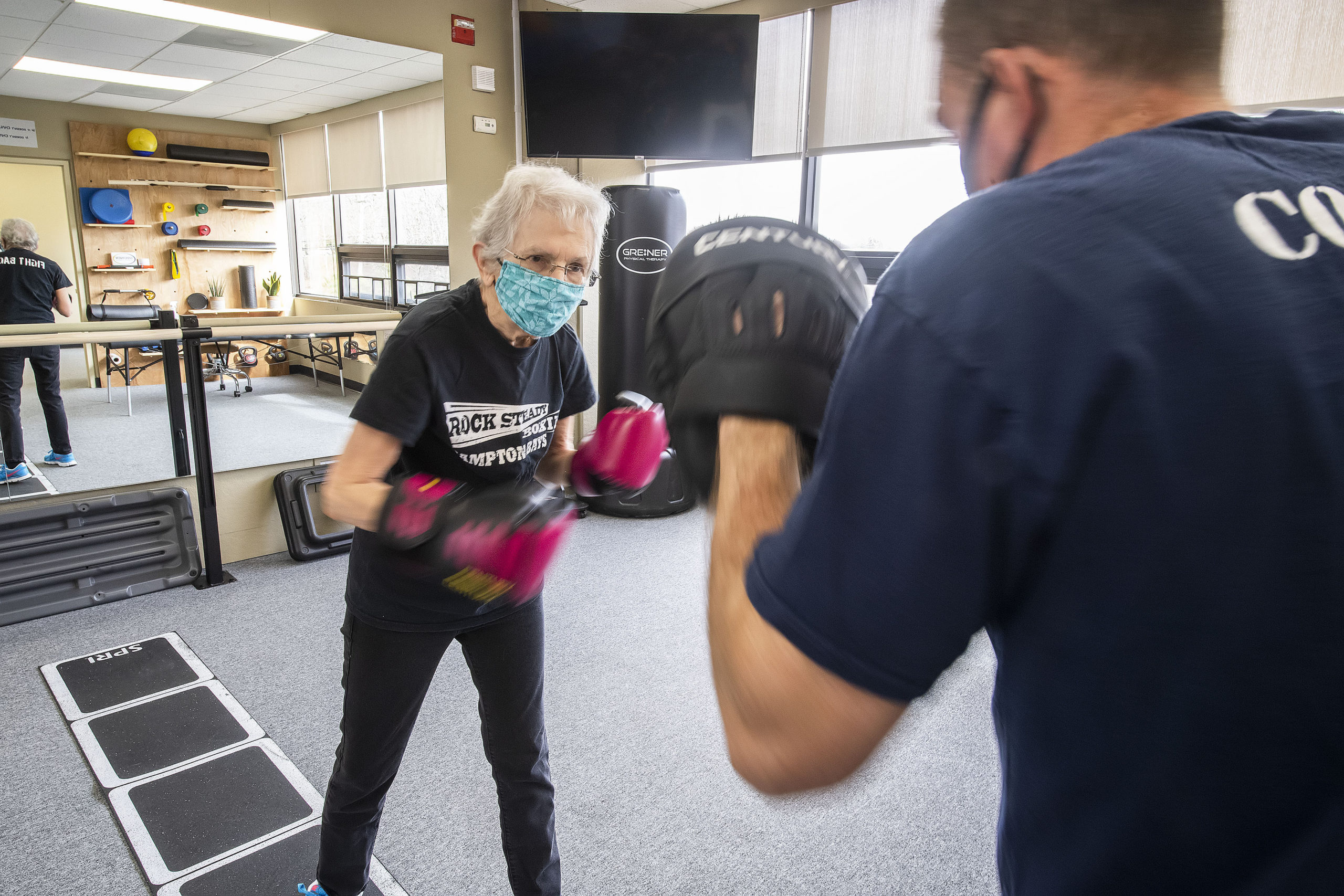 Seth Greiner of Greiner Physical Therapy does a Rock Steady Boxing workout with Parkinson's patient Janet Barr at the Greiner Physical Therapy studio in Speonk.