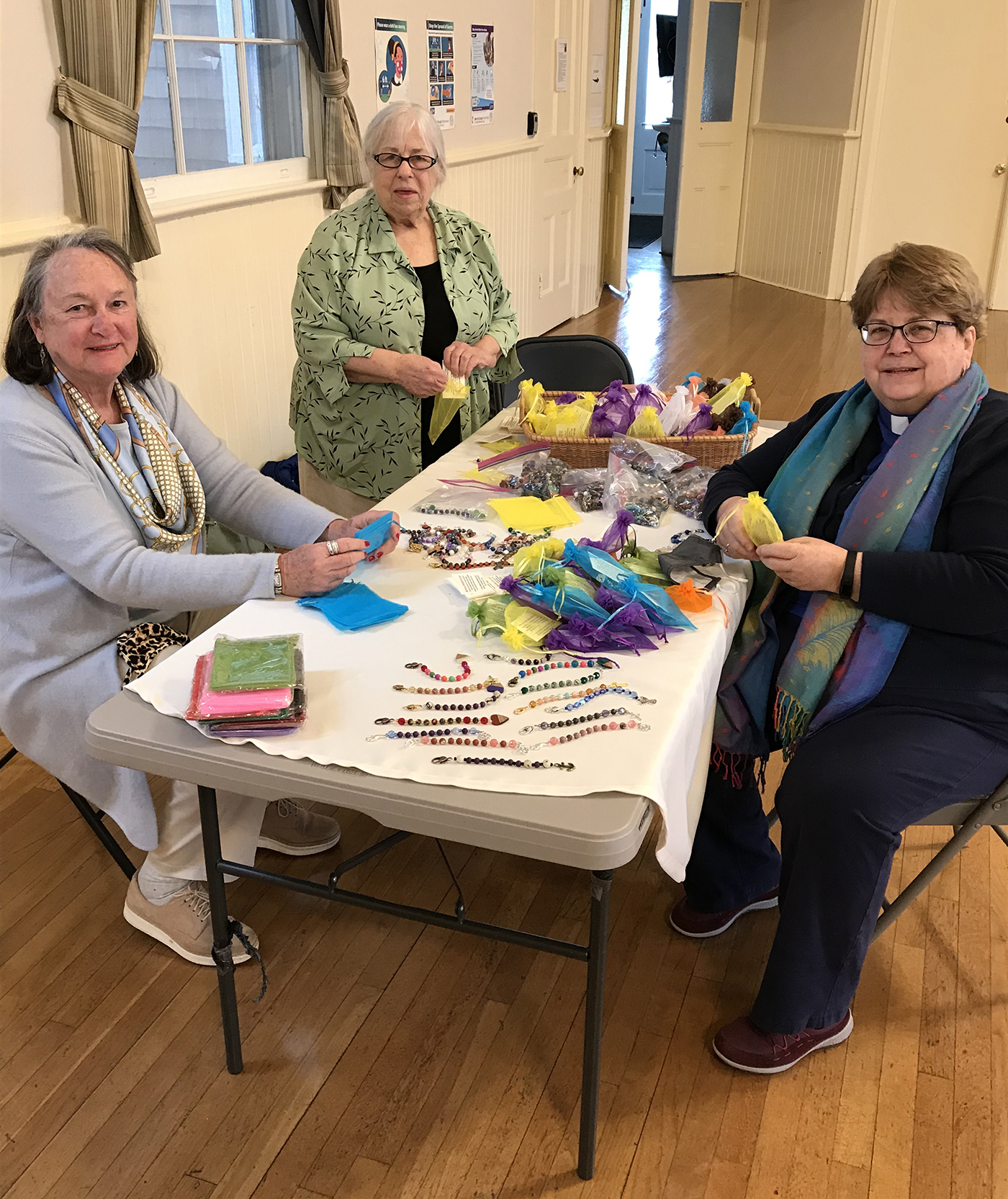 Carol Gilbert, from left, Dorothy Wienecke, and Rev. Joanne Utley package some of the 700 strands of prayer beads made by Hamptons United Methodist Church.