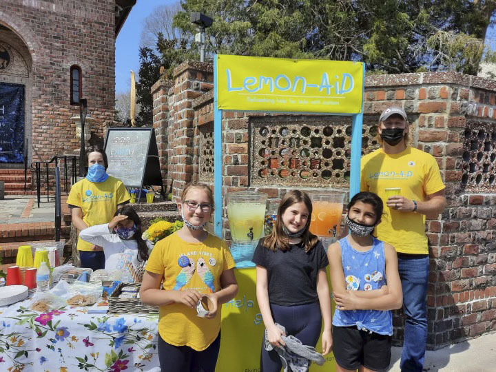 Students in Nick Epley’s after school service club spent part of their Saturday raising money for the Flying Point Foundation for Autism by volunteering to run its Lemon-AID stand outside the Southampton Arts Center.
