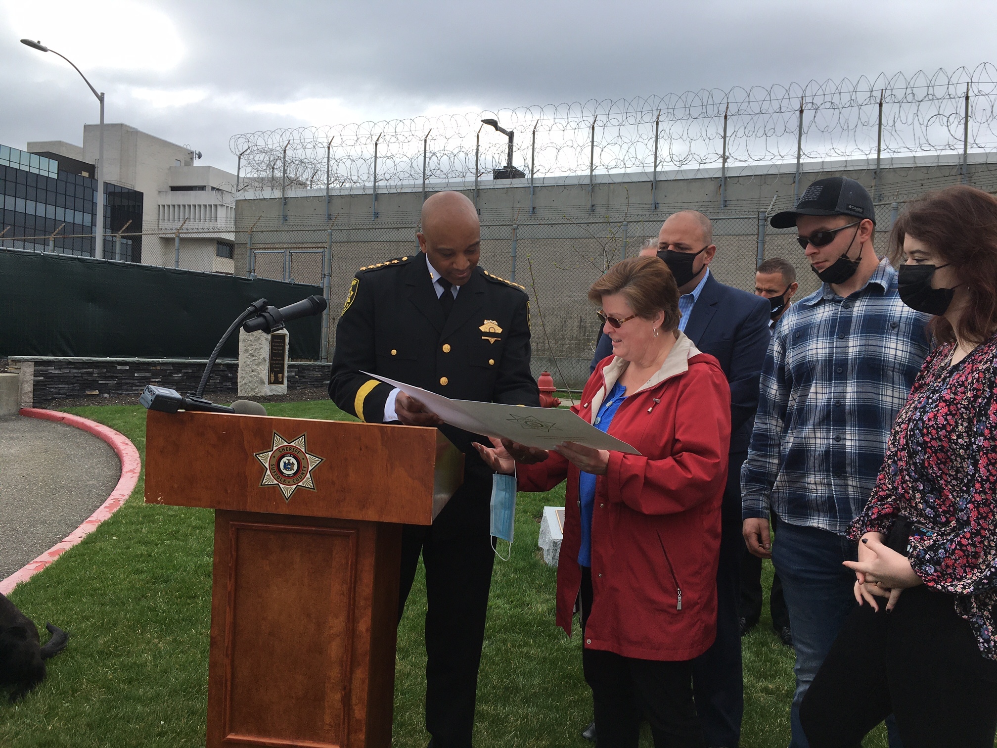 Sheriff Errol D. Toulon Jr. presents Stacey Reister and family with a proclamation .