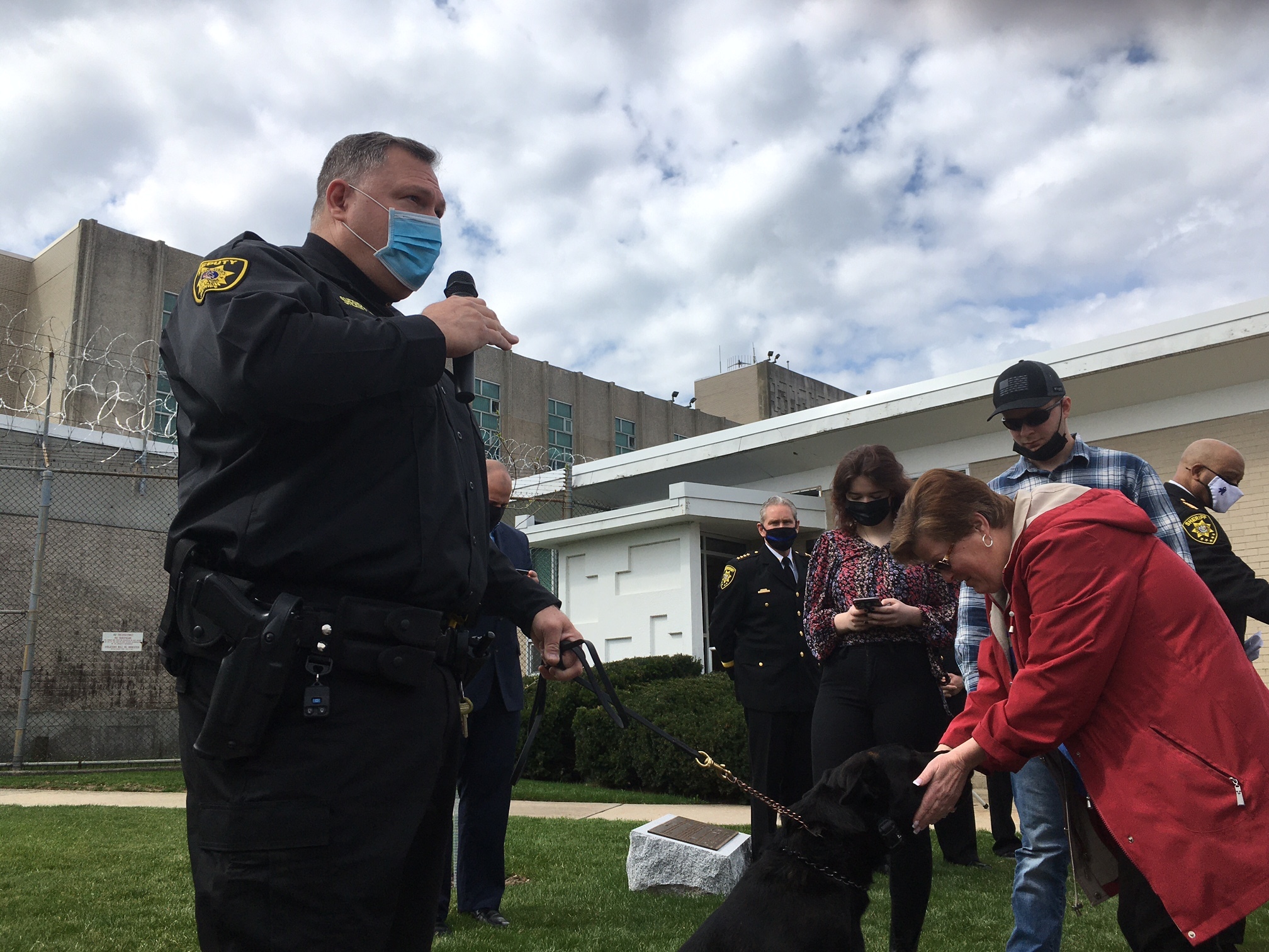 Deputy Sheriff Jason Korte describes training for K9 Reis as Stacey Reister gets to know the pup.
