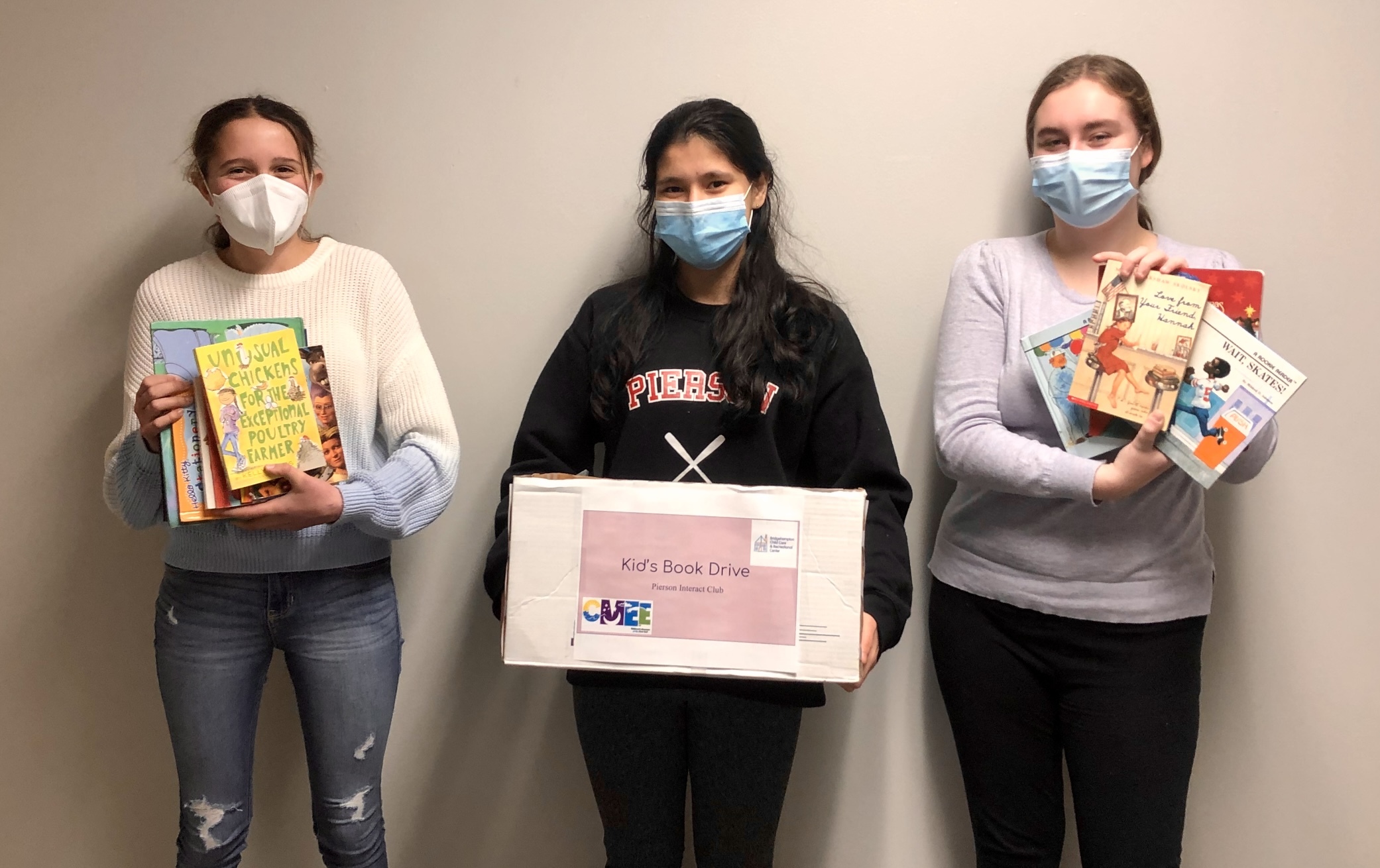 From left, Interact Club members Izzy Caplin, Ava Garabedian and Olivia Martin, collected book donations at Pierson High School to support the Bridgehampton Childcare Center.