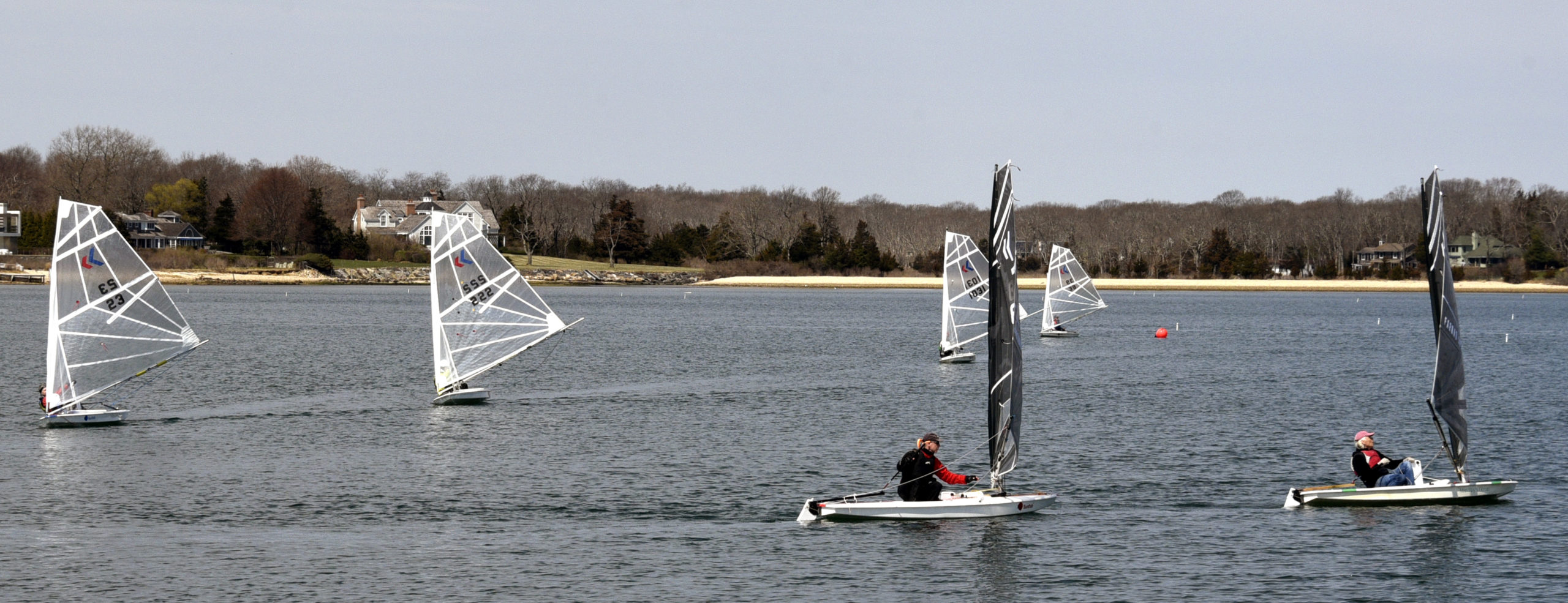 Foreground, black sails, from left: Jim Merrill and Scott Sandell. Background, white sails, from left: Gloria Franzee, (#23), Mark Webber (#222), Rachel Beardsley (#1031) and Brenna Gilroy (39).
