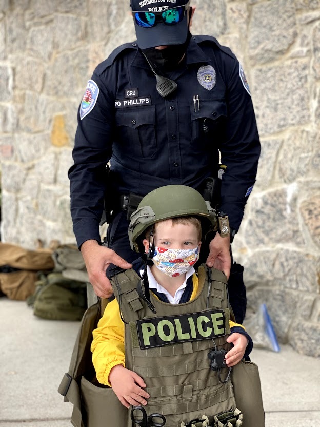Pre-K student, Adler Kanas, tries on the protective gear used by Southampton Town Police Officers during Raynor Country Day School's Police Expo.