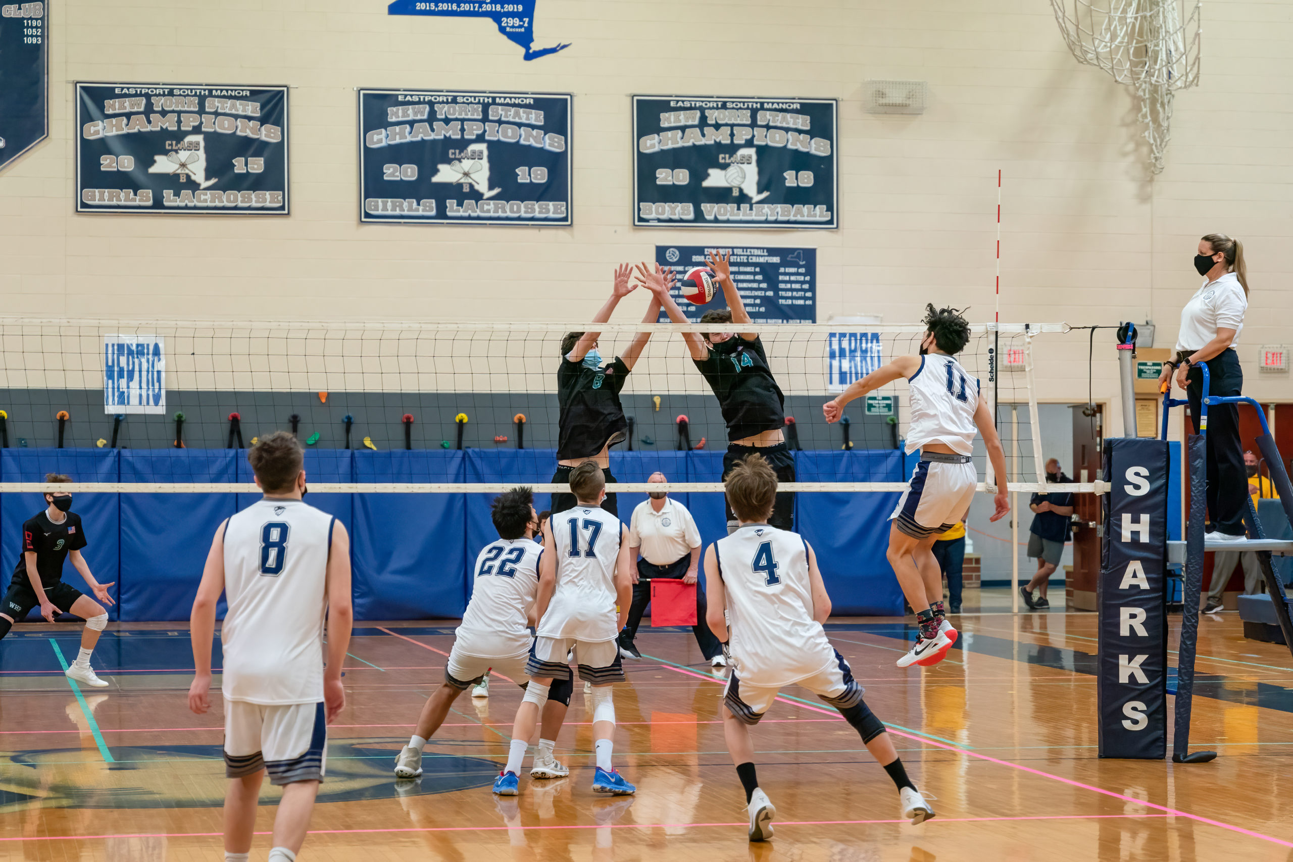 Hurricanes Colbie Mason, left, and Daniel Haber set up a block at the net.