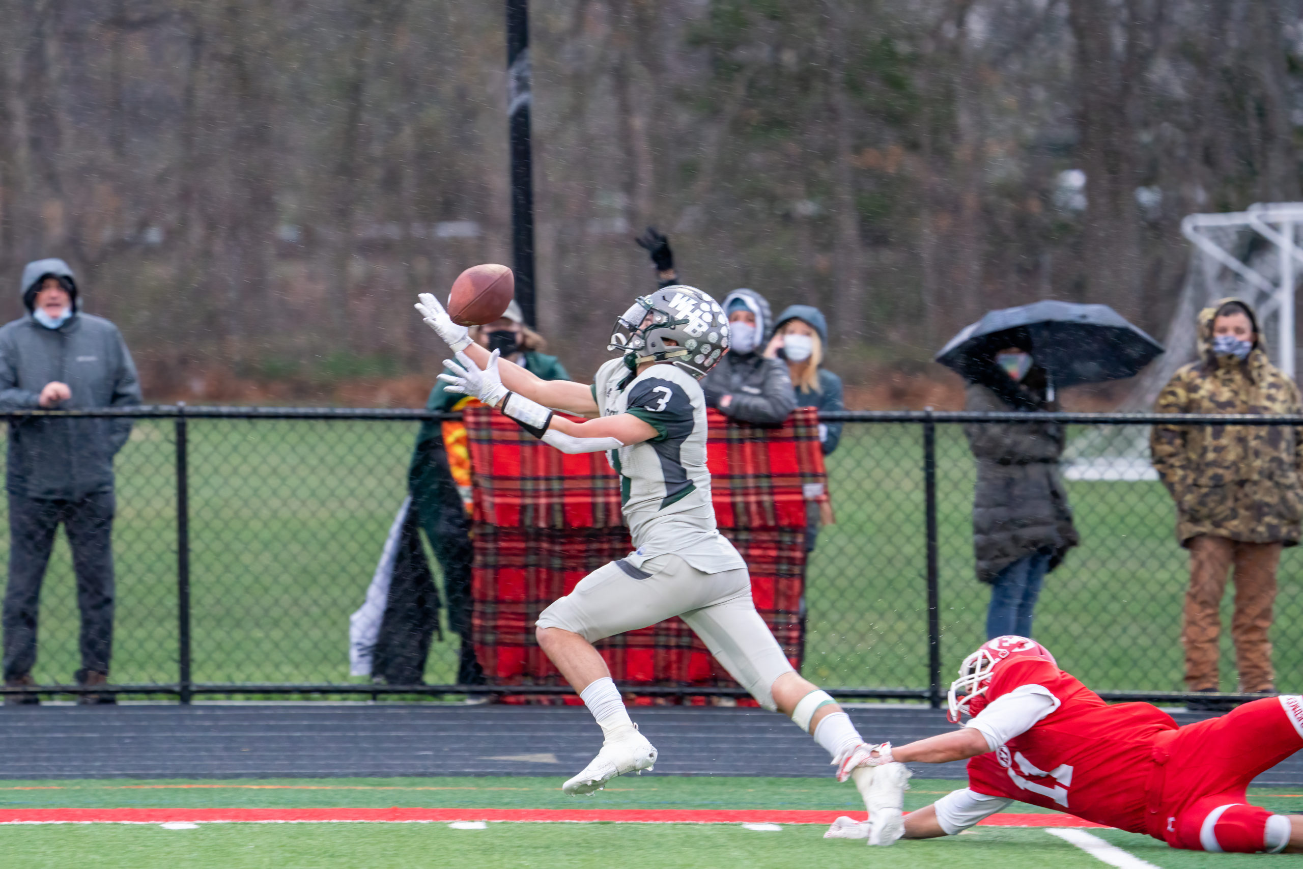 Owen Spizuoco catches a deep pass from quarterback Christian Capuano down the sideline, eludes an East Islip defender, and scurries into the end zone to pull Westhampton Beach closer to East Islip's lead with just under a minute left in the first half.