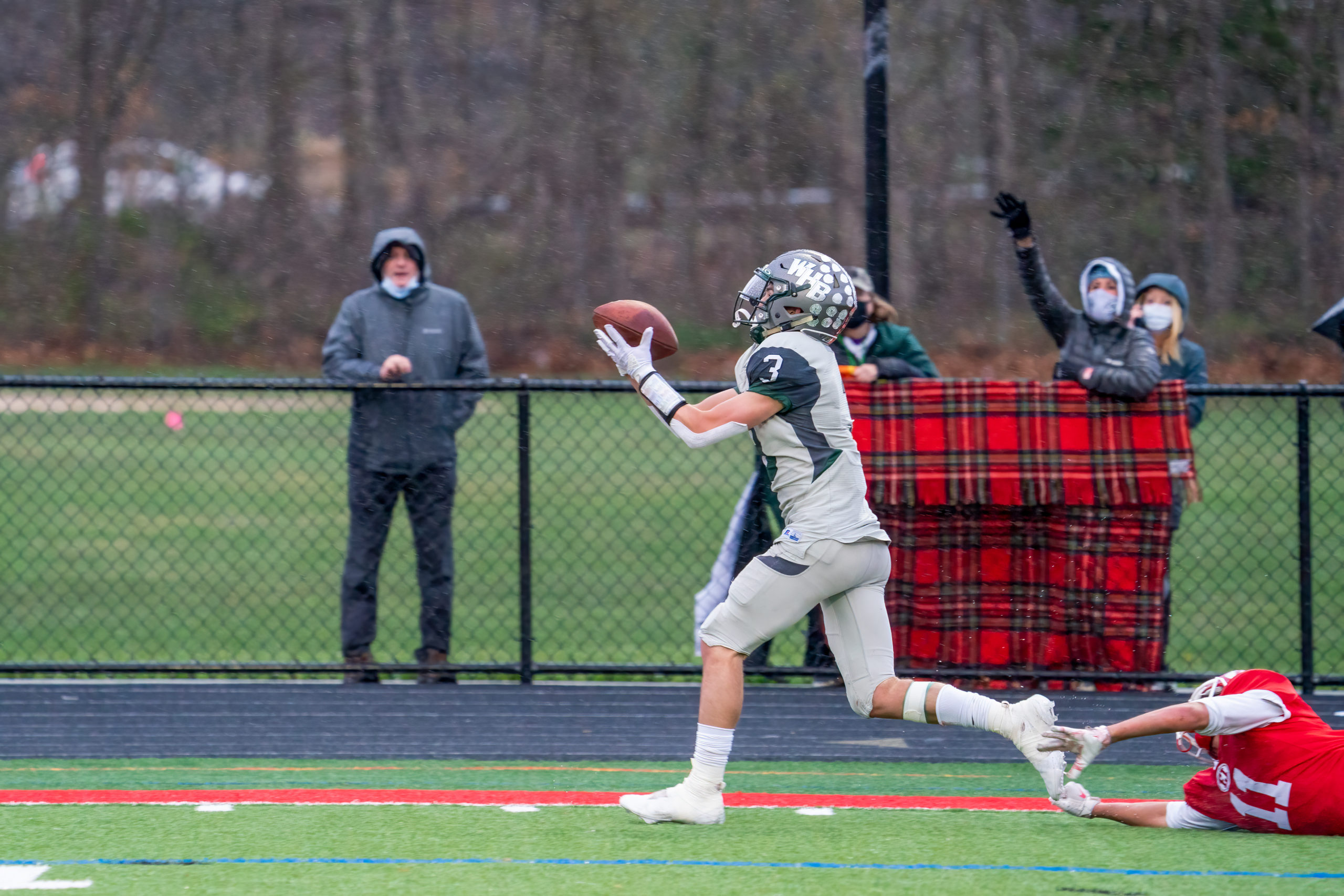 Owen Spizuoco catches a deep pass from quarterback Christian Capuano down the sideline, eludes an East Islip defender, and scurries into the end zone to pull Westhampton Beach closer to East Islip's lead with just under a minute left in the first half.
