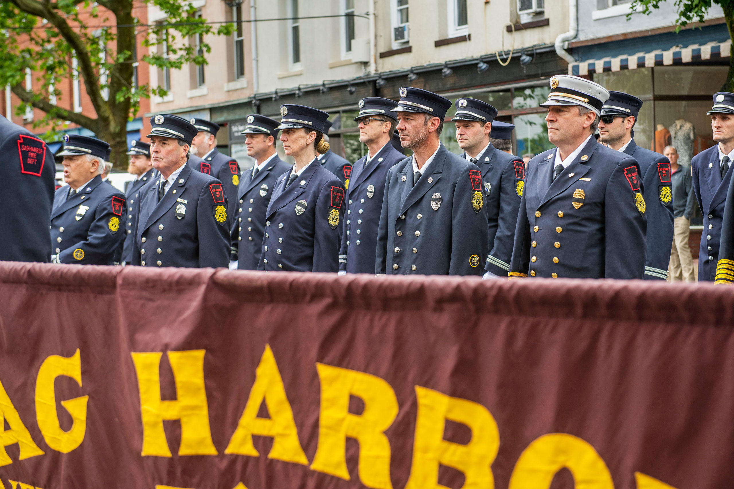 Sag Harbor firefighters stand in formation during a ceremony in front of the Main Street firehouse during the 2021 Memorial Day parade and ceremonies in Sag Harbor on Monday.  MICHAEL HELLER