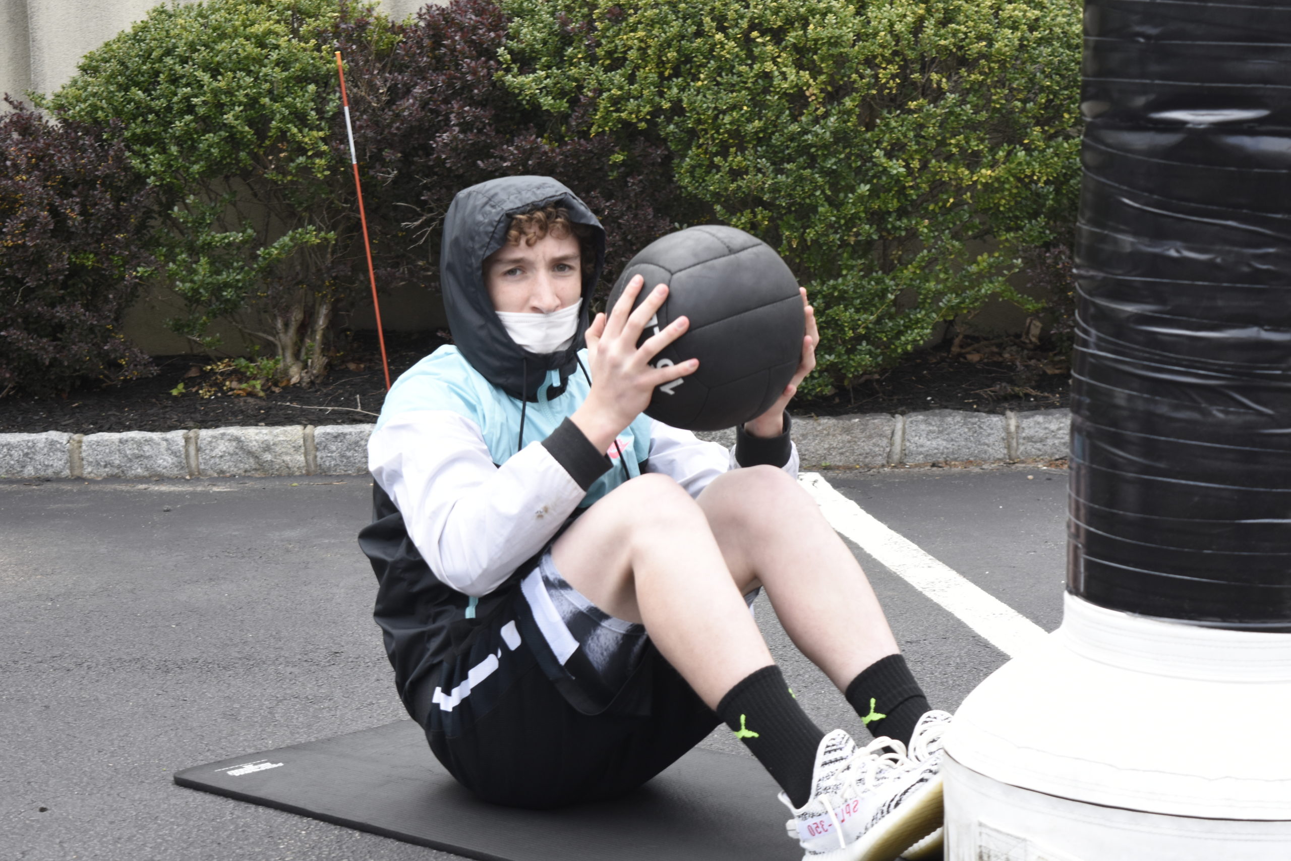 Chandler Tuttle works out with a medicine ball at Hill Street Boxing on Friday.