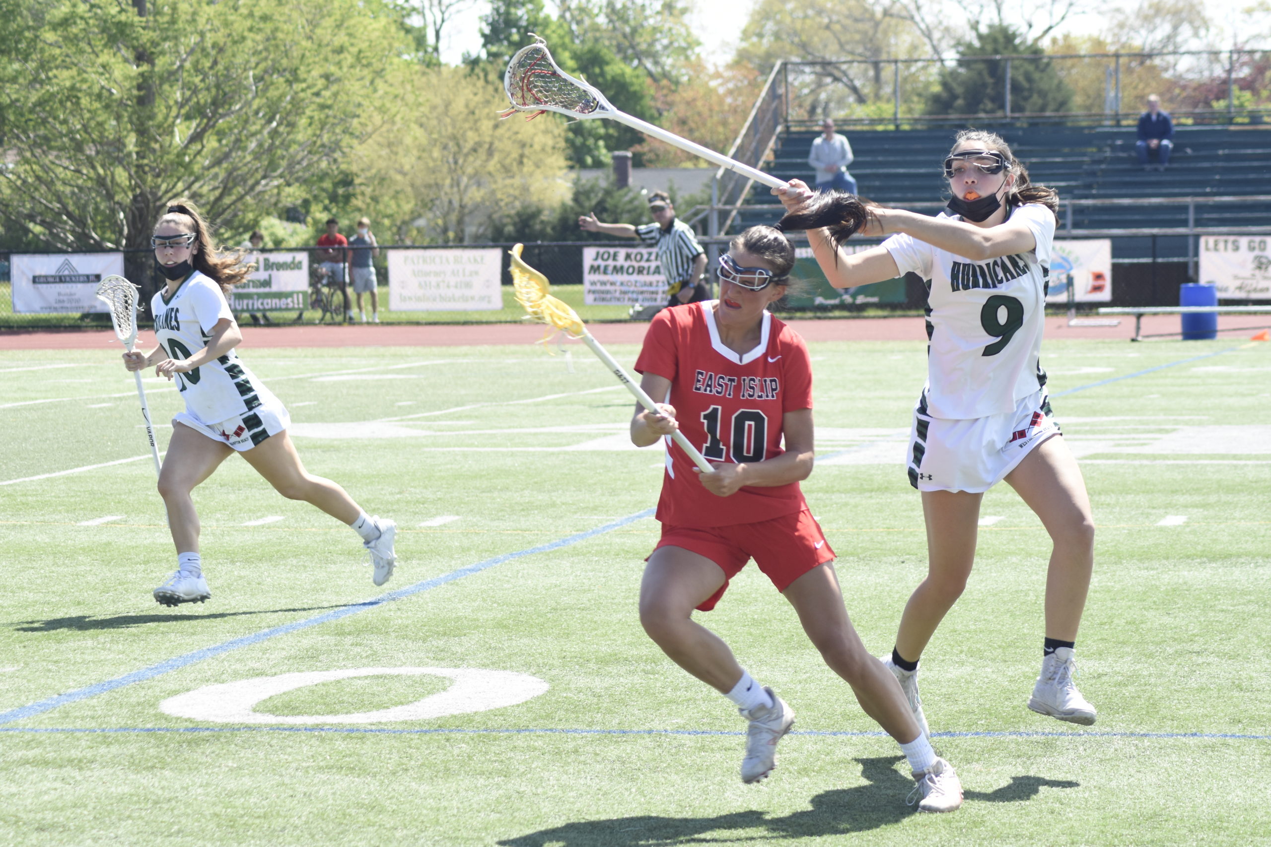 Westhampton Beach sophomore Reilly Mahon accidentally catches the head of an East Islip player with her stick.