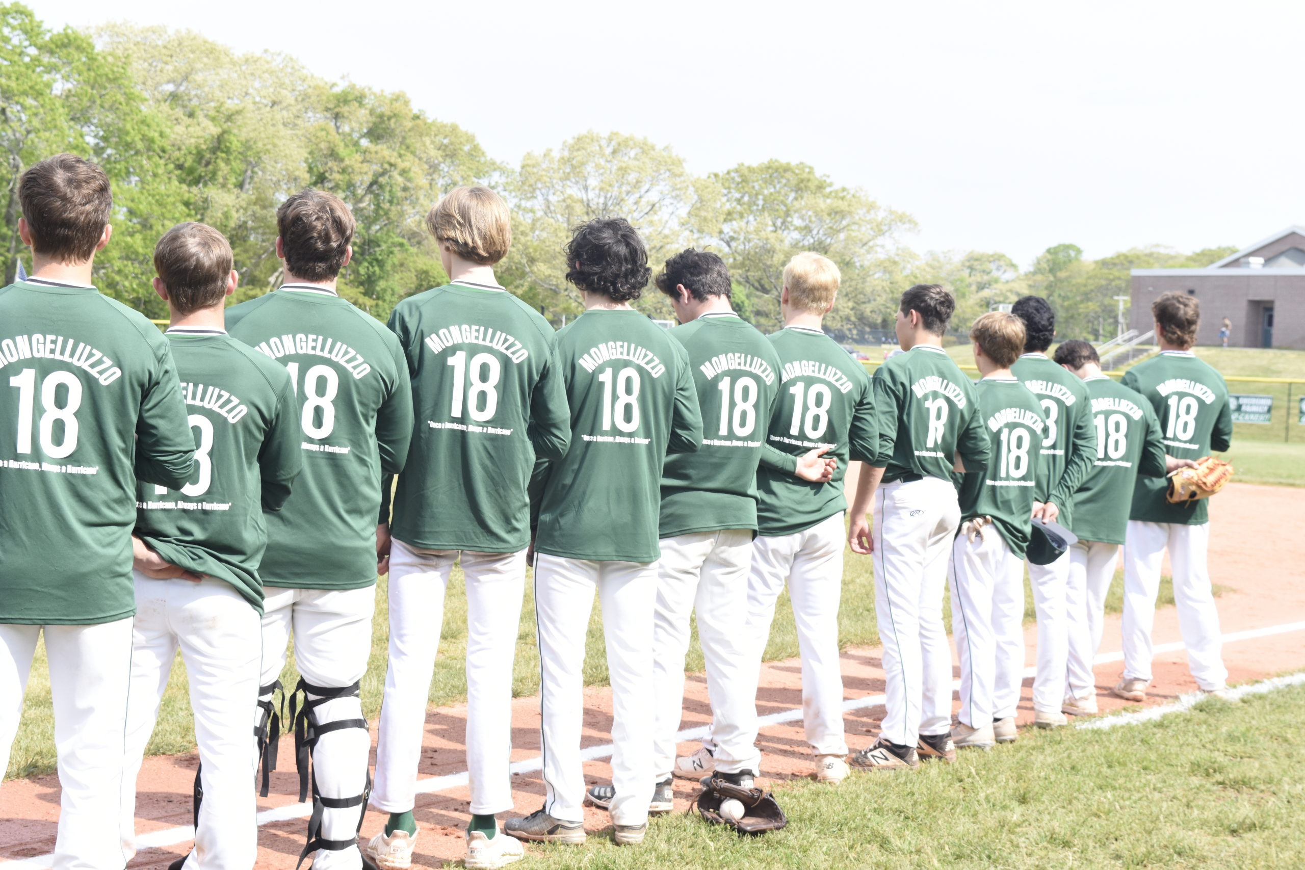 The Westhampton Beach varsity baseball team dons shirts in memory of alumnus Gianni Mongelluzzo, a three-year varsity starter for the Hurricanes.