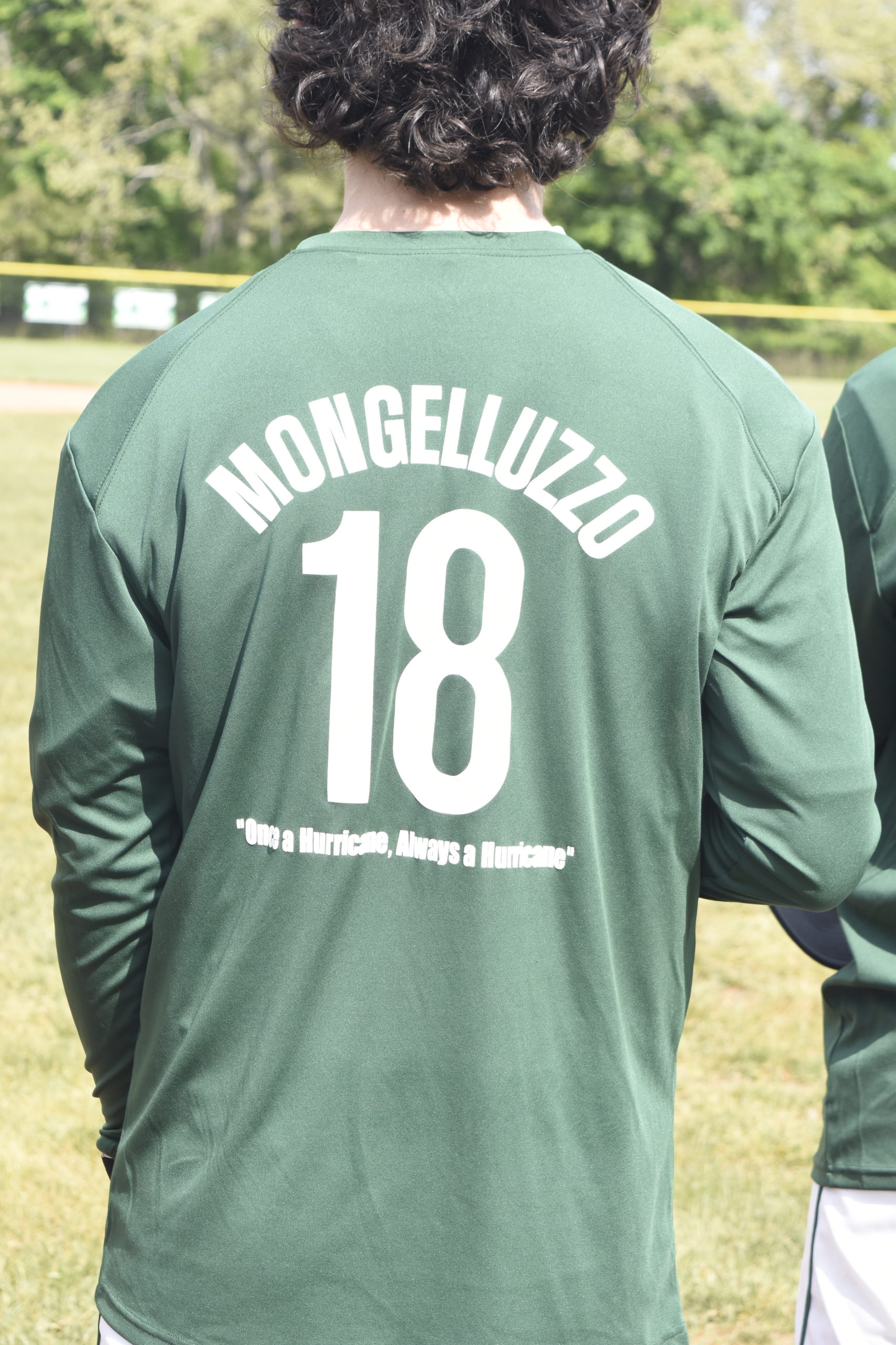 The Westhampton Beach varsity baseball team dons shirts in memory of alumnus Gianni Mongelluzzo, a three-year varsity starter for the Hurricanes.