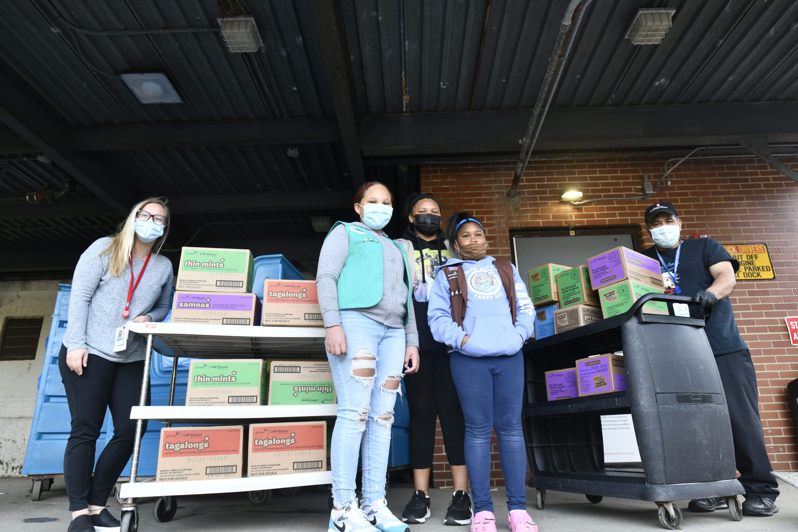 Members of Girl Scout Troop 642, Gabriella Gaines, Syvana Smith and Jordyn Smith, from the Shinnecock Nation dropped off 300 boxes (25 cases) of Girls Scout Cookies for the employees at Stony Brook Southampton Hospital on Sunday afternoon. Helping the girls unload are hospital employees Victoria Stanek and Cesar Flores.  DANA SHAW