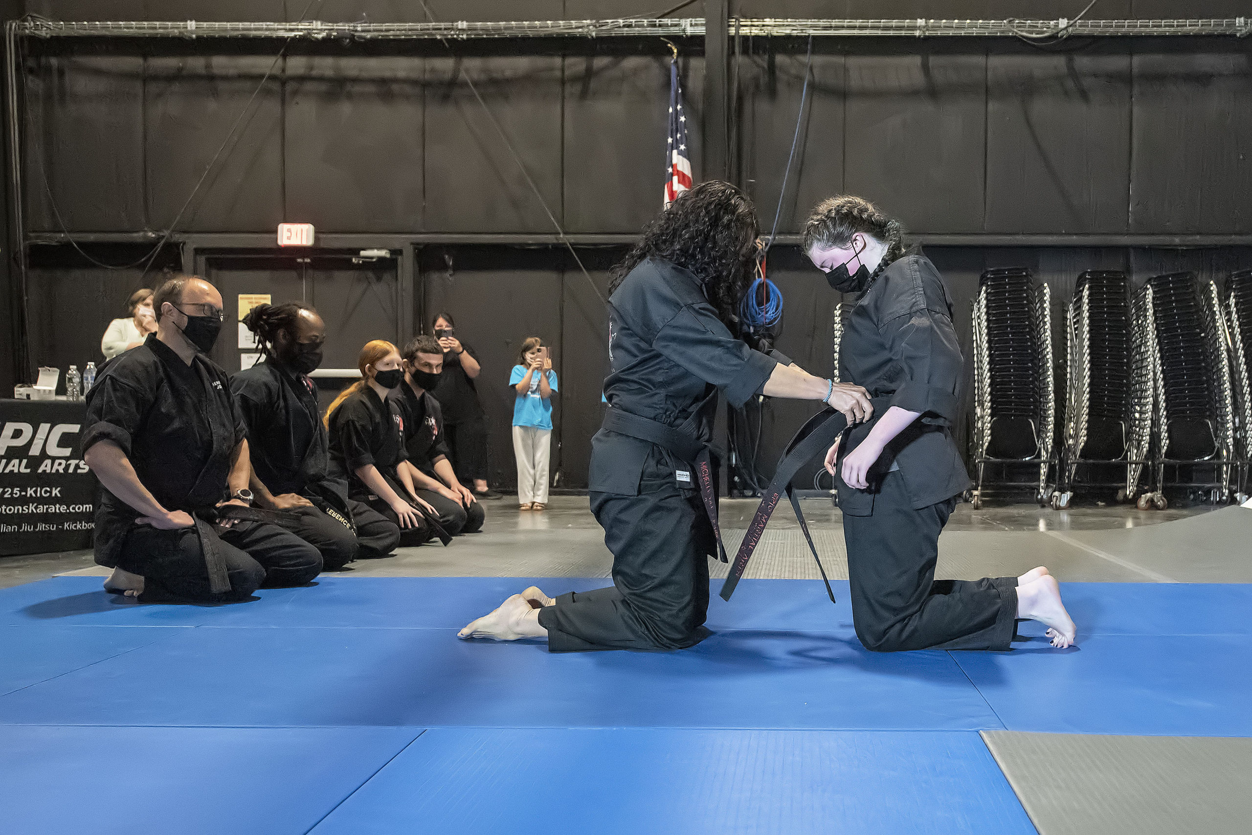 Emily Glass receives her black belt from EPIC Martial Arts Instructor Michelle Del Giorno.
