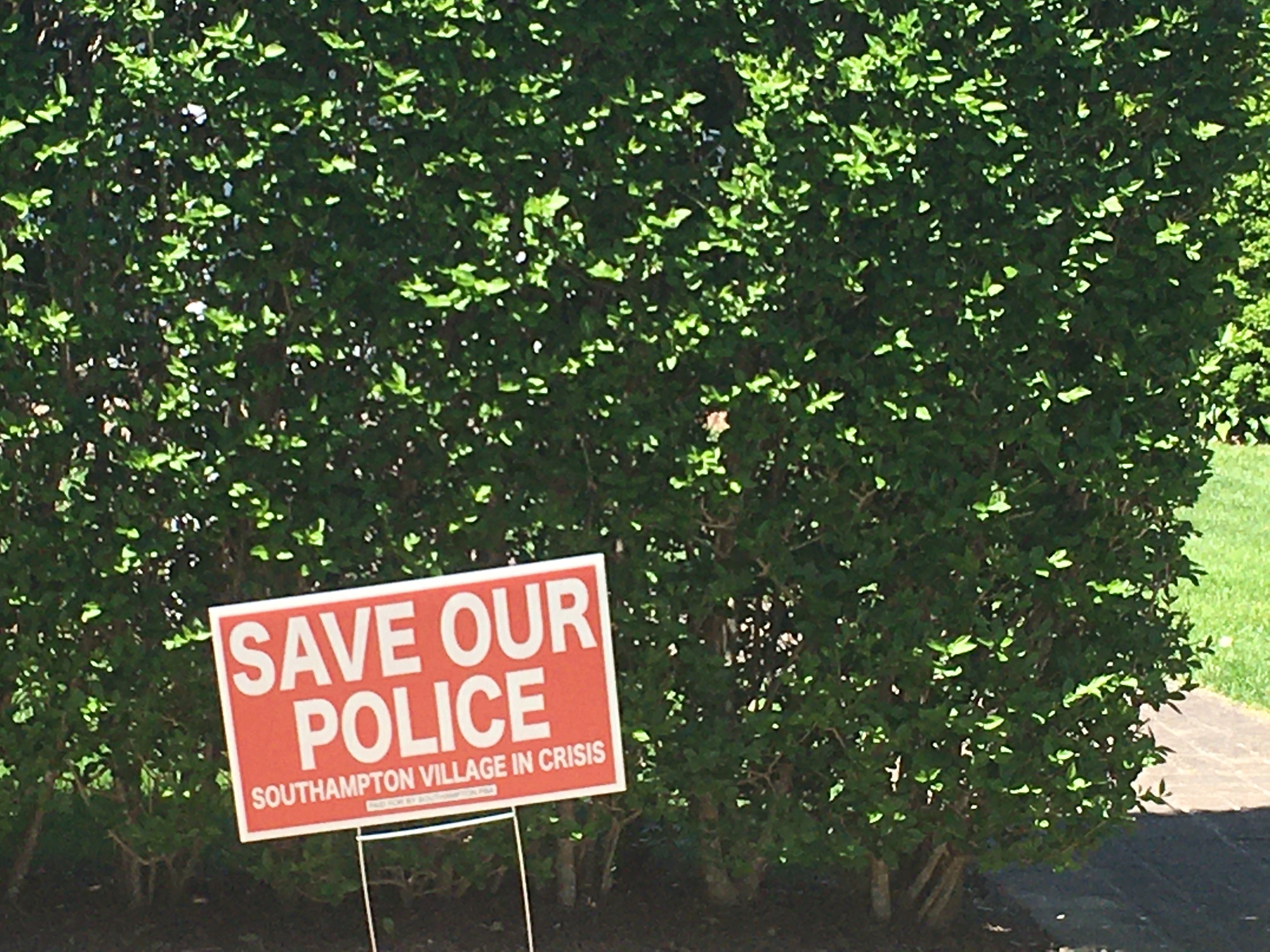 Signs in support of Southampton Village Police popped up as the operational report was underway.