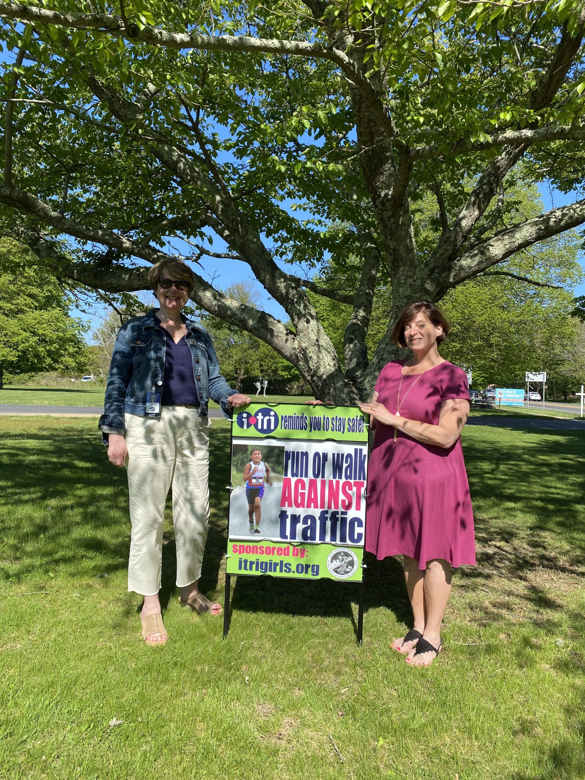(Left to right) East Hampton Town Councilwoman Kathee Burke-Gonzalez and i-tri founder Theresa Roden with one of the newly installed safety signs in East Hampton.