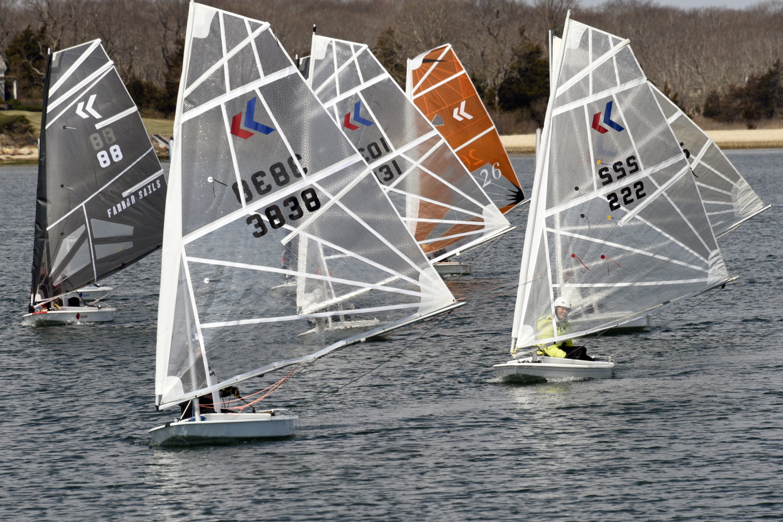 What a difference a week makes! Breakwater Yacht Club’s End of Winter “Sunnies” Frostbite Regatta, March 28th, was literally blown out of the water with wind gusts well over 30 knots on Sag Harbor. This past Sunday's first race of the spring season was summer-like in comparison, with warm winds out of the southwest at no more than 10 knots. Another Sunfish MK sail premiered Sunday, an orange beauty Scott Sandell cut and stitched on his kitchen floor, his makeshift sail loft! This sail is taller, with a shorter foot, making it even more responsive to the slightest commands. It proved to be a Formula 1 rocket on the racecourse.   MICHAEL MELLA