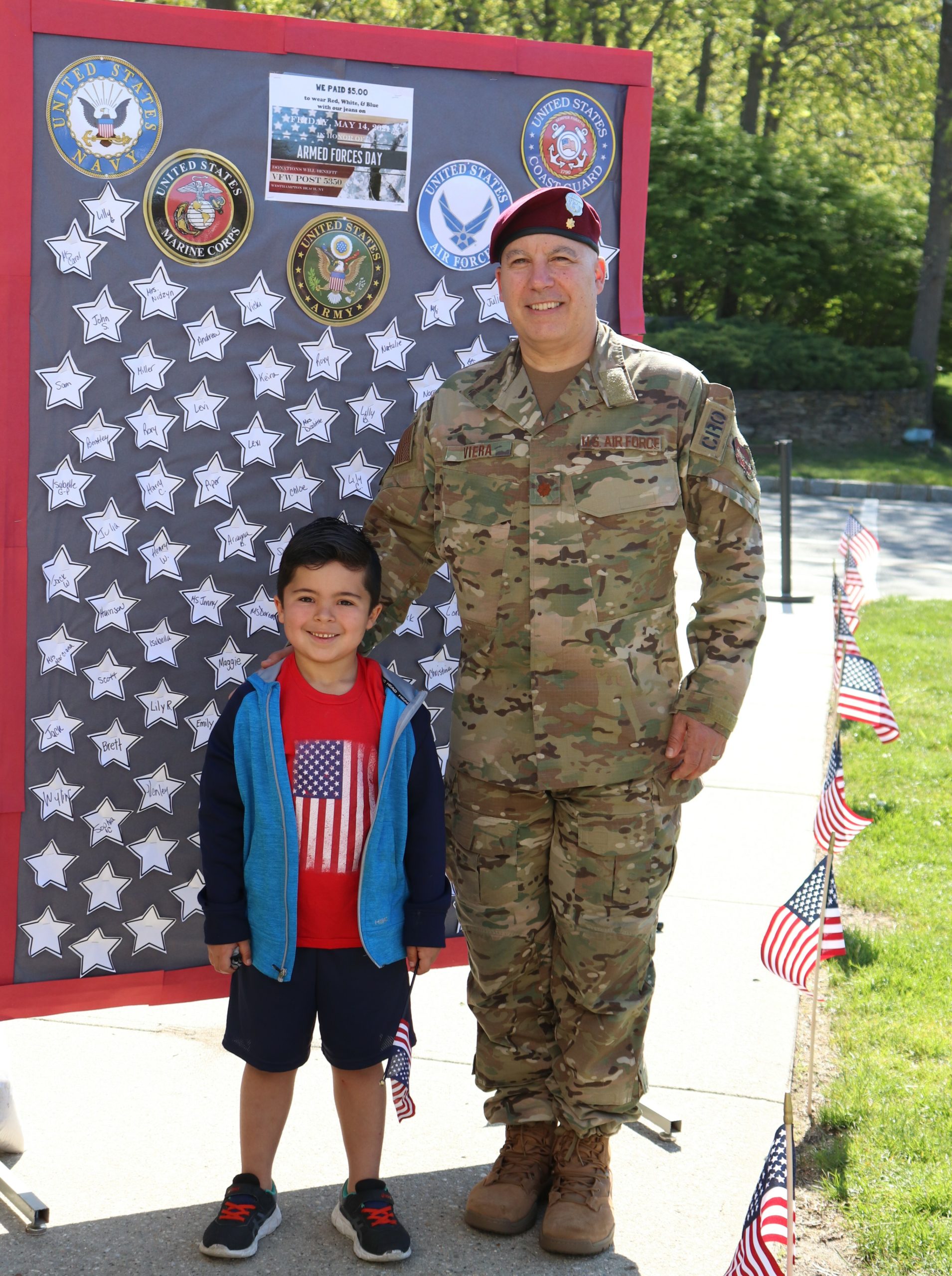 Kindergarten student, Xavier Viera, joins his friends and classmates as they honor his dad and fellow service members during Raynor Country Day School's Armed Forces Ceremony.