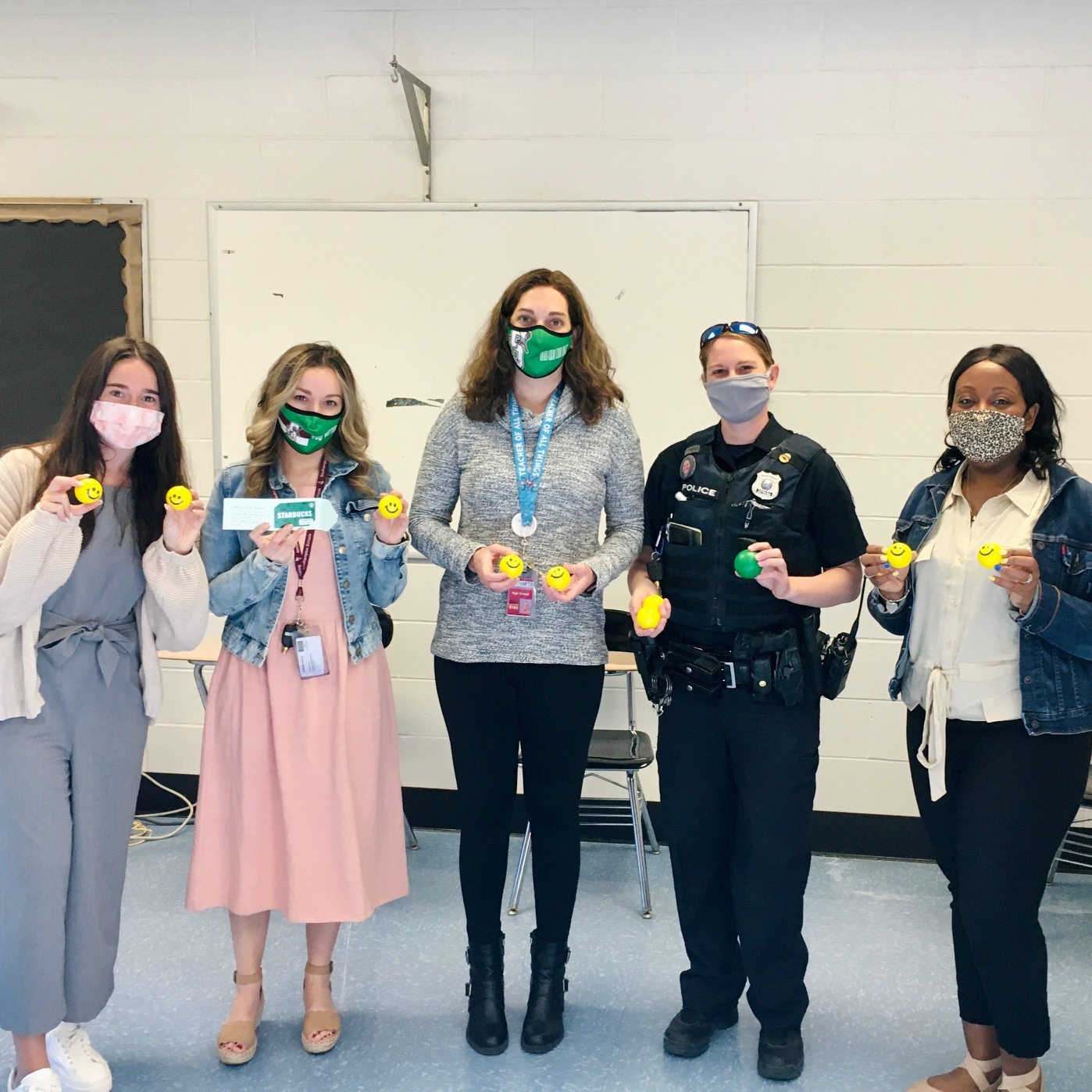 Brooke Ross, Arlette Flores, Kimberly Spellman-McClain, Lisa McCulley and Natasha Jeffries hold stress balls used in the scavenger hunt promoting mental health awareness at Southampton High School.