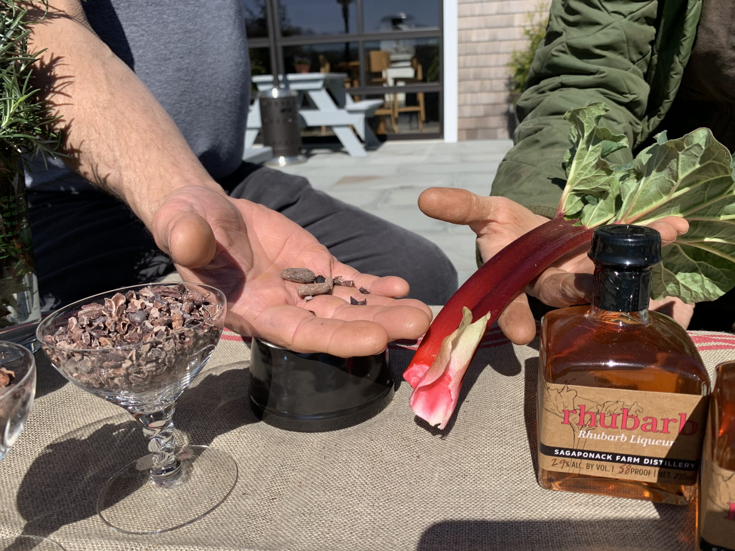 Chef Steven Amaral and Marilee Foster hold ingredients at  Sagaponack Farm Distillery for their new chocolate bars — the “Whiskey Bar